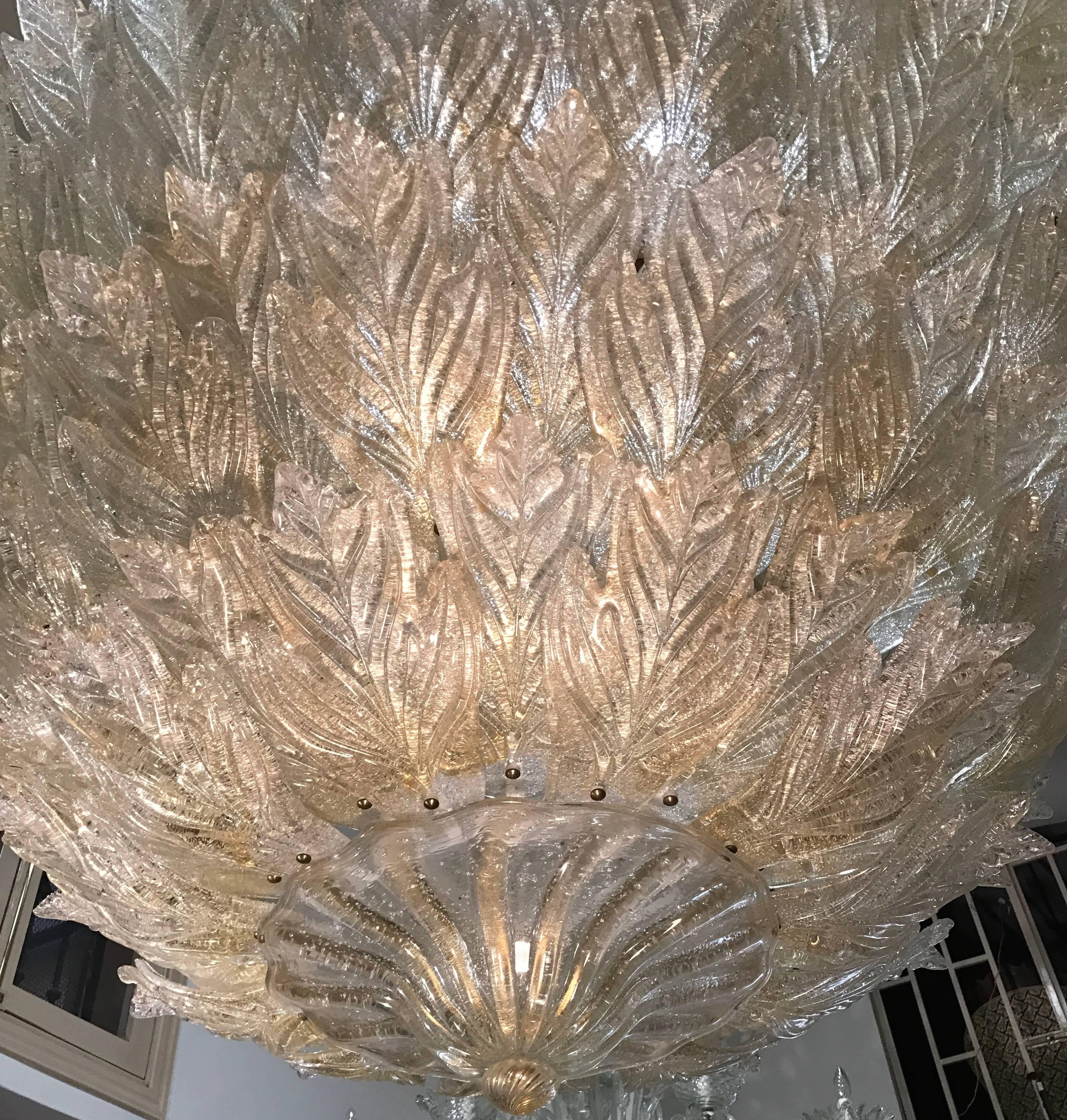 This extraordinary large fixture with circa 150 leaves arranged on four levels, the glasses are embellished with gold inclusions.
   