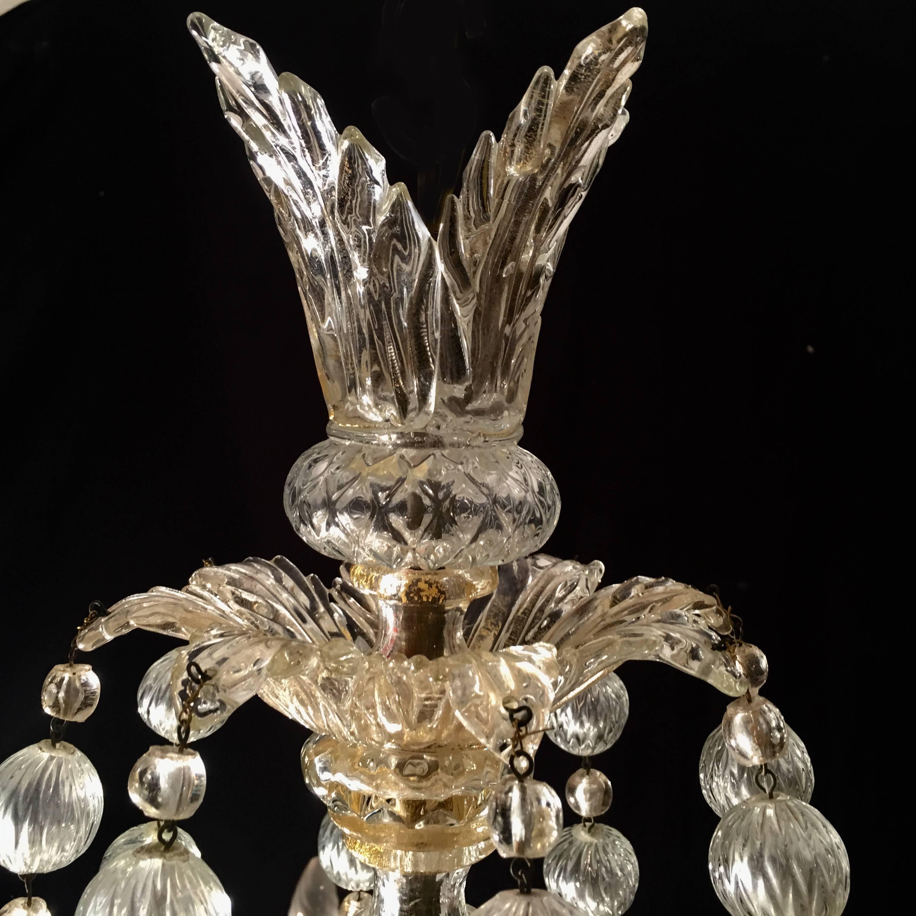 Magnificent chandelier with eight arms with details gold inclusions. Eight heads of lions are the eight ball falls background. The chandelier comes from the private collection of Baron Von Plant in Catania Sicily.
        