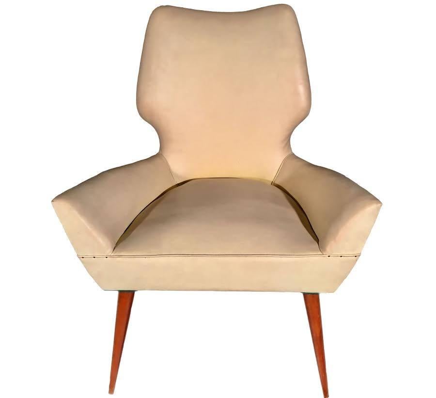 This pair of Mid-Century chairs features the unique design style of Gio Ponti. Two-tone upholstery and curved back and armrests make these a stylish selection for any room.