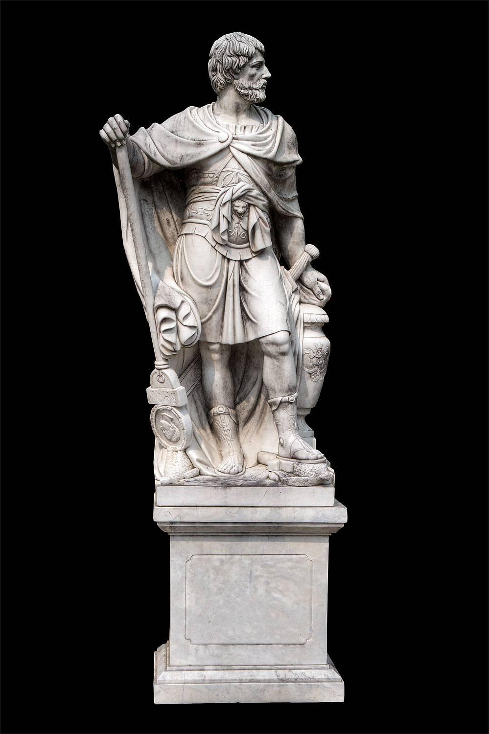Standing figure of Julius Caesar wearing a Tunic and holding a billowing drapery with a composition marble square-section pedestal.
Base:
H 85 cm, lxp=80x65 cm
 Sculpture H=200 cm

Total height
H=285 cm.
