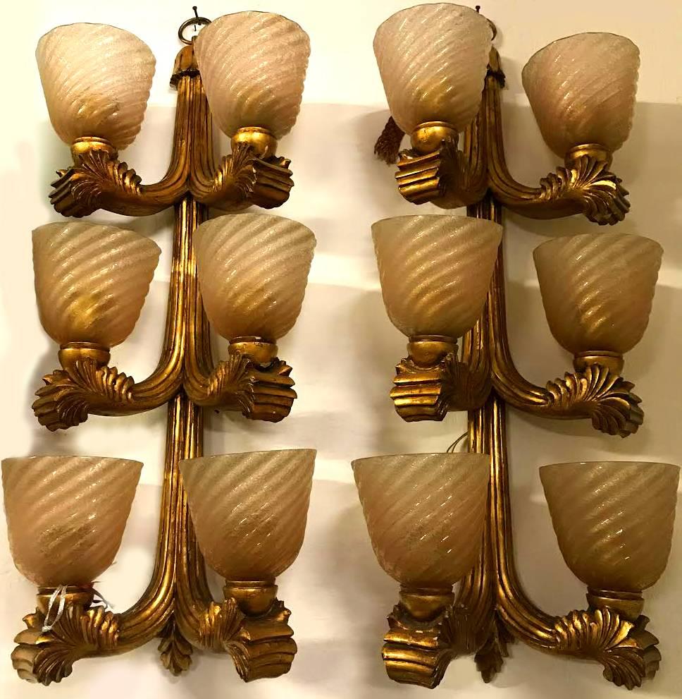 Pair of sophisticated beauty sconces. Carved and golden wood, glazed with golden inclusions by Archimede Seguso.
Produced by Colli Company, Turin, Italy, 1940s.