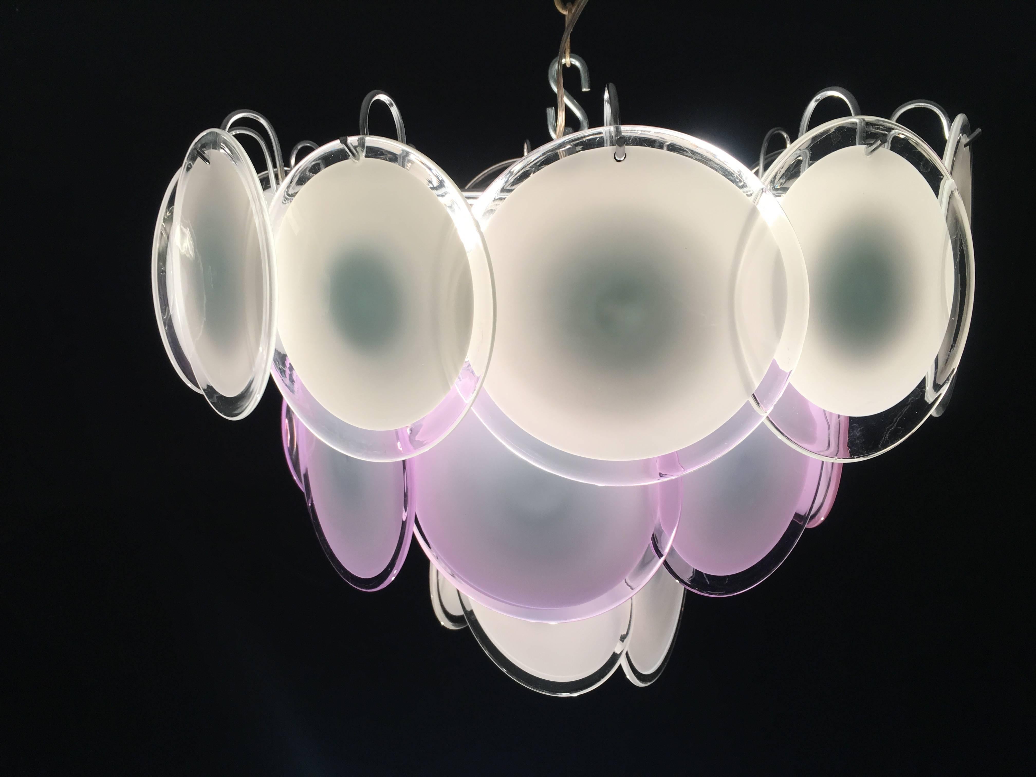 The 24 pink and white discs of precious Murano glass are arranged on floor levels. Nine lights.
 