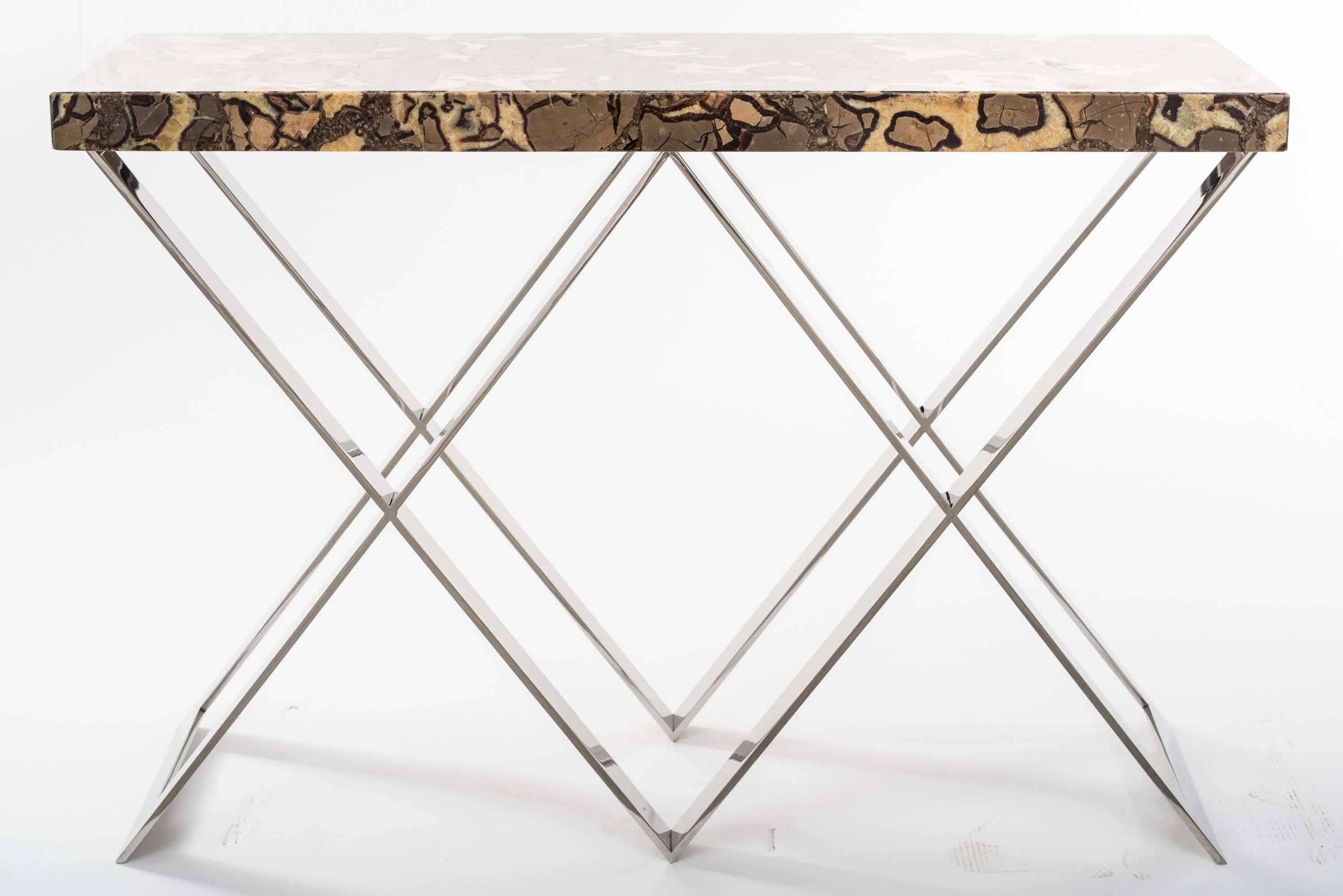 Exceptional console Tables with double X-shaped chrome base .
The marble tops of these pair of consoles are made with a semi-precious stone called “septaria”, which is formed by overlapping mineral deposits and is crossed by crystal streaks. Slabs