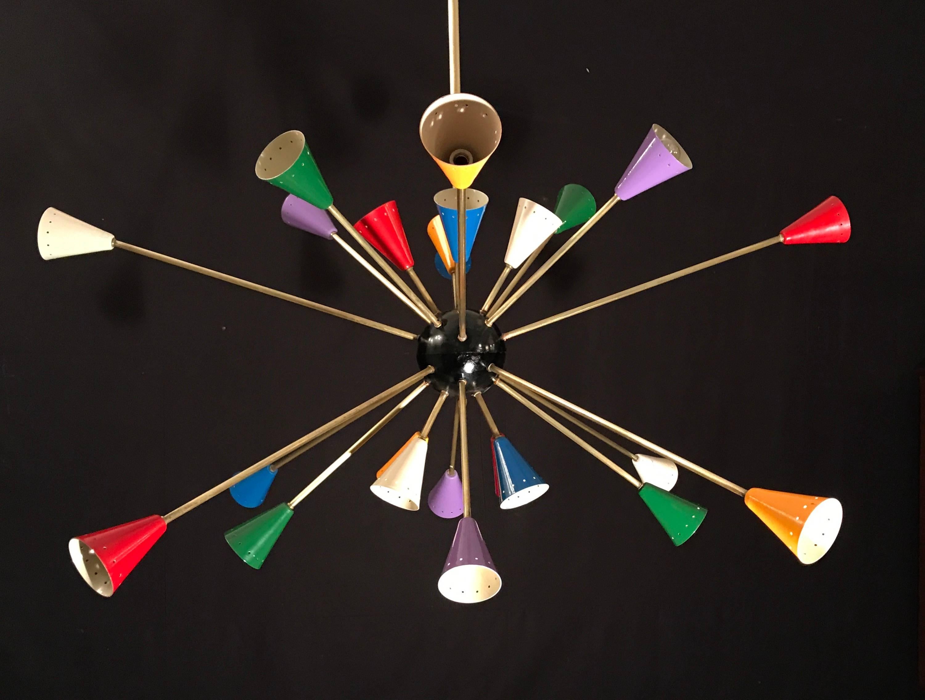 Features 24 brass arms, each sporting multicolored, perforated shades. Black central Sphere.
Bearing a circa 1970s label in the canopy.
Commonly called ' Sputnik' chandeliers today (in honor of the Russian satellite that inspired a war and a design