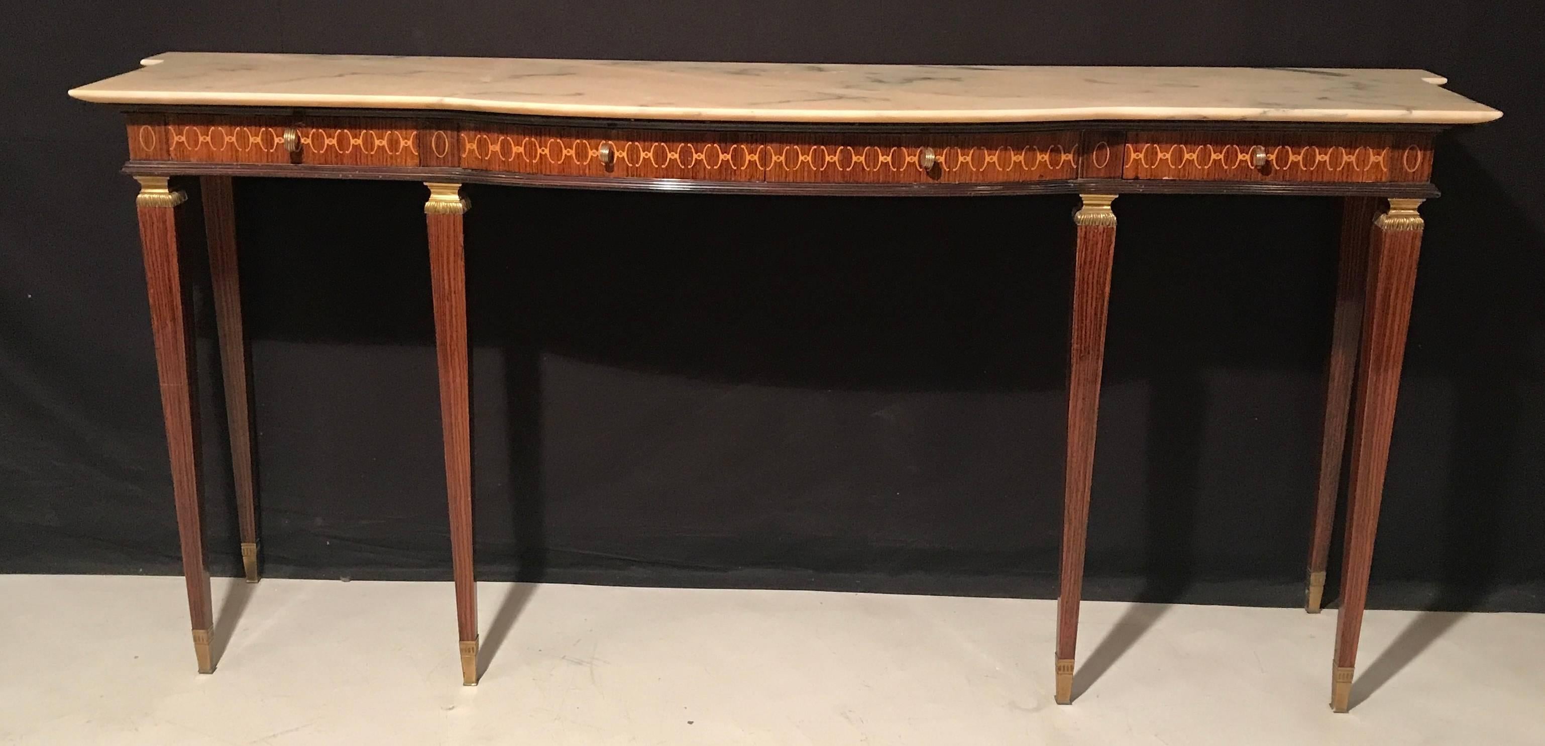 With a marble top, a frieze marquetry inlaid in geometric form with four drawers. Square tapering legs with finely chiseled bronze mounts.
Designer, Paolo buffa.