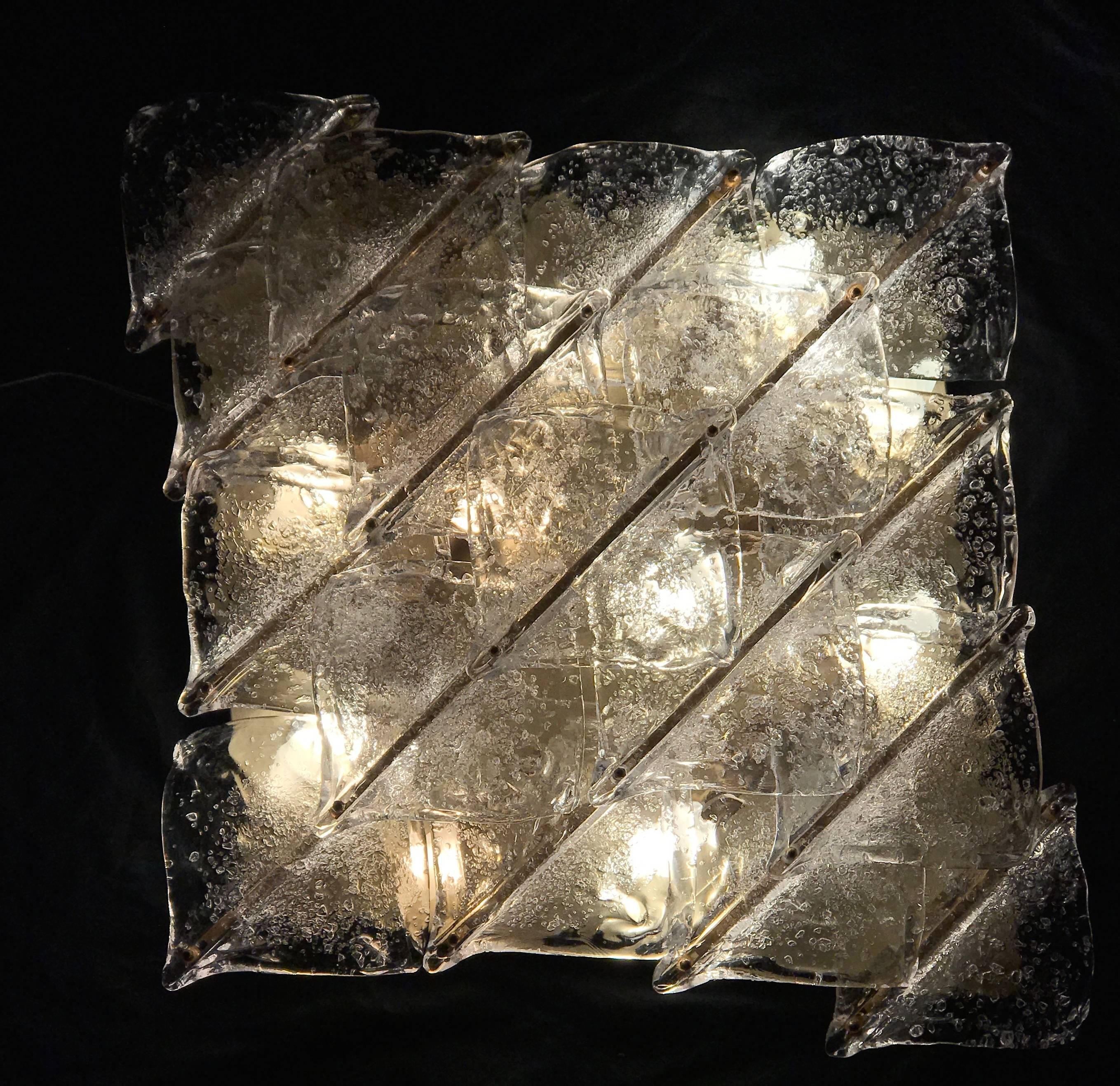  Features  clear and frosted Murano waves  glasses , supported by  brass frame  in a very good vintage condition with ten candelabra light sockets . E 14. 
We can Rewire for US. Standards. 
It can be mounted either as a ceiling light or as a  Wall