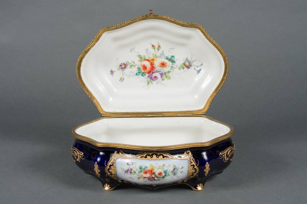 French antique bronze mounted and painted sevres style cobalt blue accessory box

France, circa 1890

Decorated with a figurative scene depicting music and literature. 

Signed on bottom right side of painting, E. Grisard

Measures: Width 13
