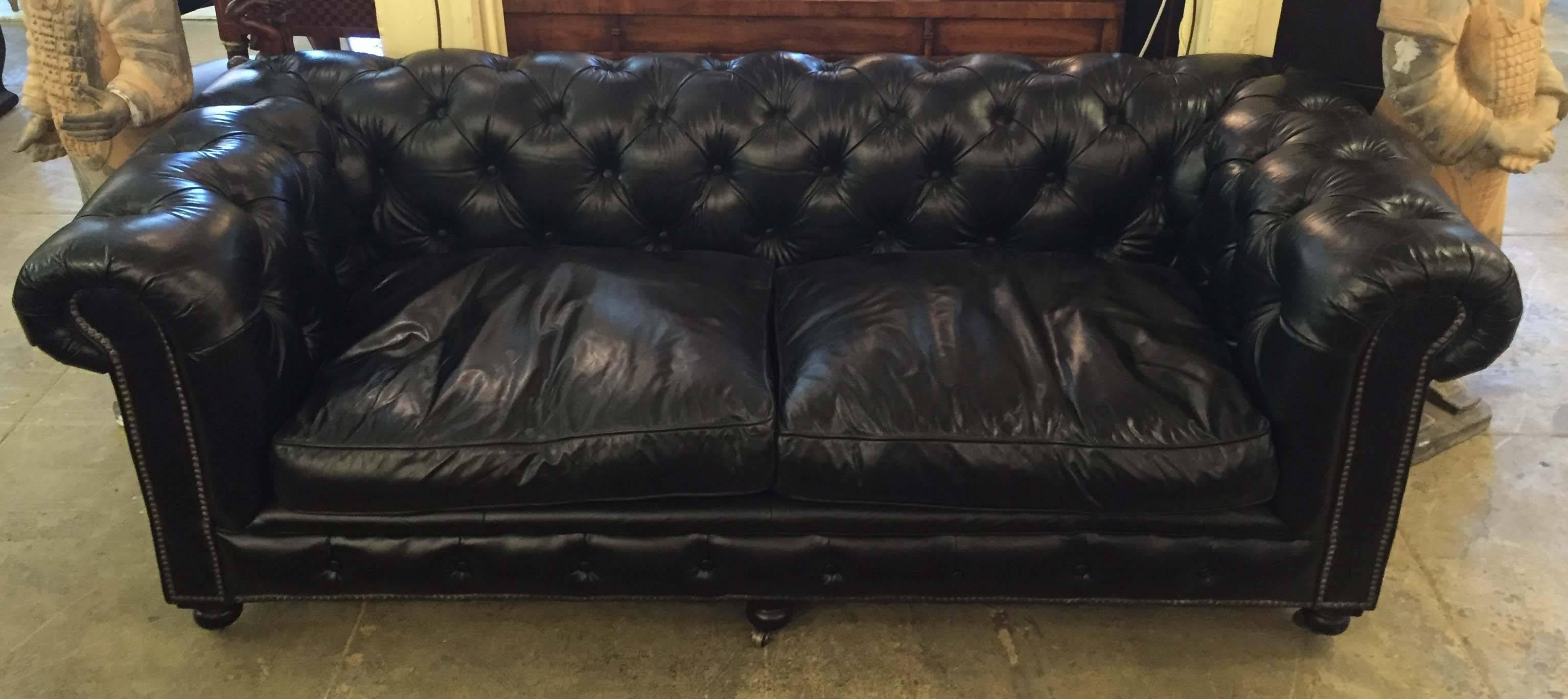 A large Ralph Lauren black leather tufted cigar couch.

The couch is all original including the wheels and is very comfortable. It has been cleaned and since then no one is allowed to sit on it. In some photos the couch might look brown due to the