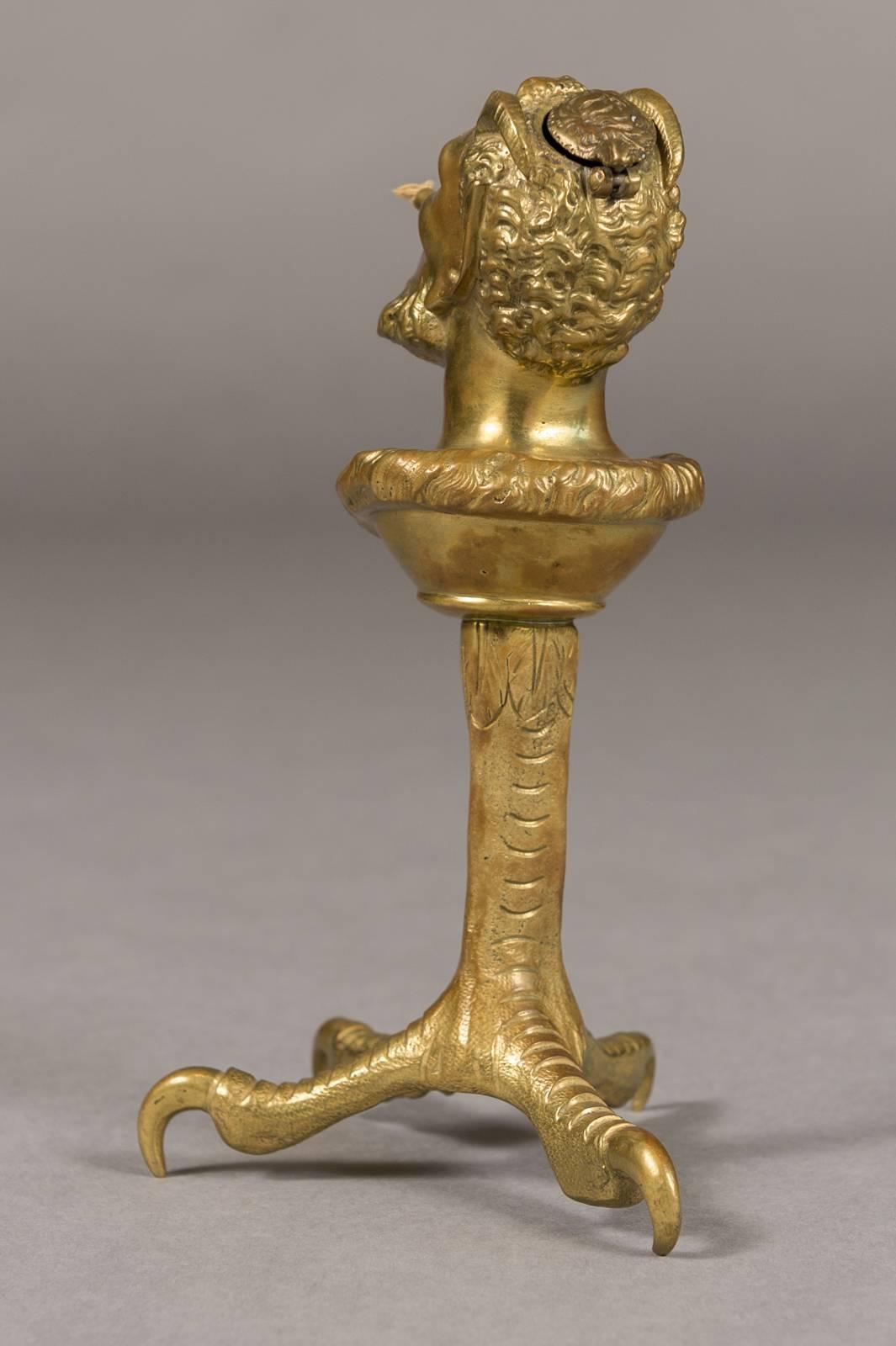 A French doré bronze cigar lighter depicting satyr mounted atop a chicken leg.

Very finely made with Satyr's head standing on a large chicken leg.

The wick extends from his mouth and fuel enters into the back of his head.

Measures: Height