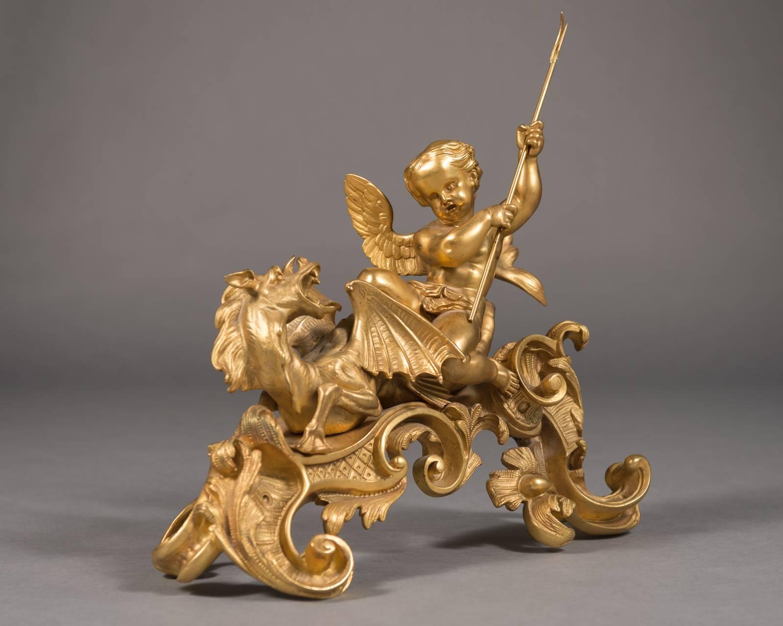 A fine pair 19th century French figural chenets depicting Cherubs & Dragons.

Having the original gilding, these fabulous chenets are breathtaking. 
Each with a winged cherub riding on top of a dragon. Both cherubs with tridents in their