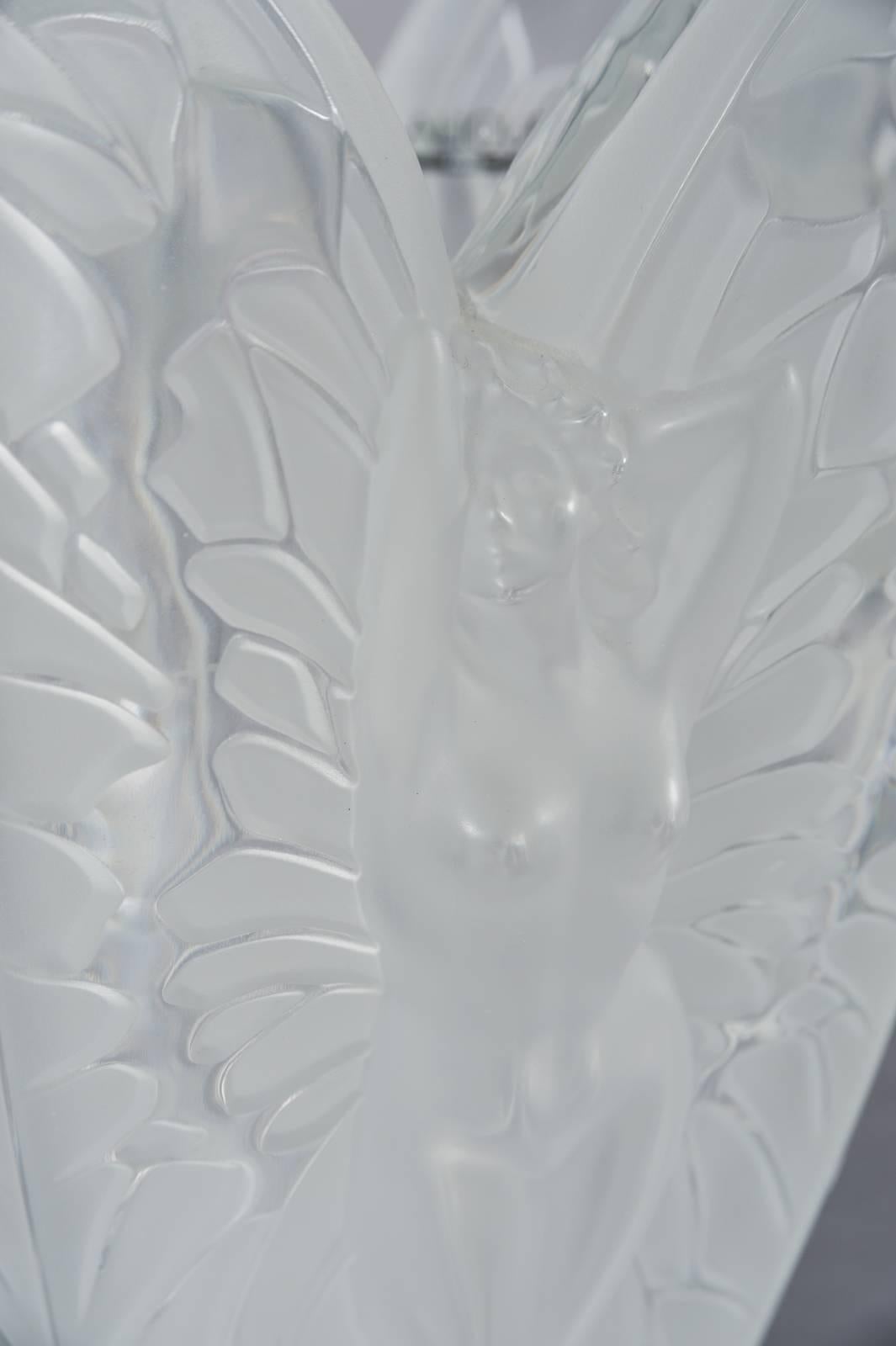 A large lalique France frosted and clear chrysalide vase.

Having five sides each with a winged nude.

Measures: Height 11.5