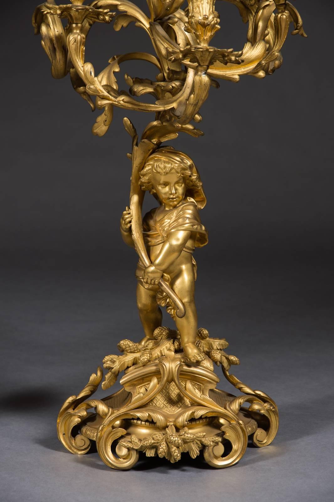 A very fine pair of 19th century French gilt bronze Napoleon III figural candelabras by Victor Raulin.
Each modeled in a form of  a standing putti supporting a branch with  a seven-arms candelabra. 

Signed: RAULIN.

Dimensions
Height: 32