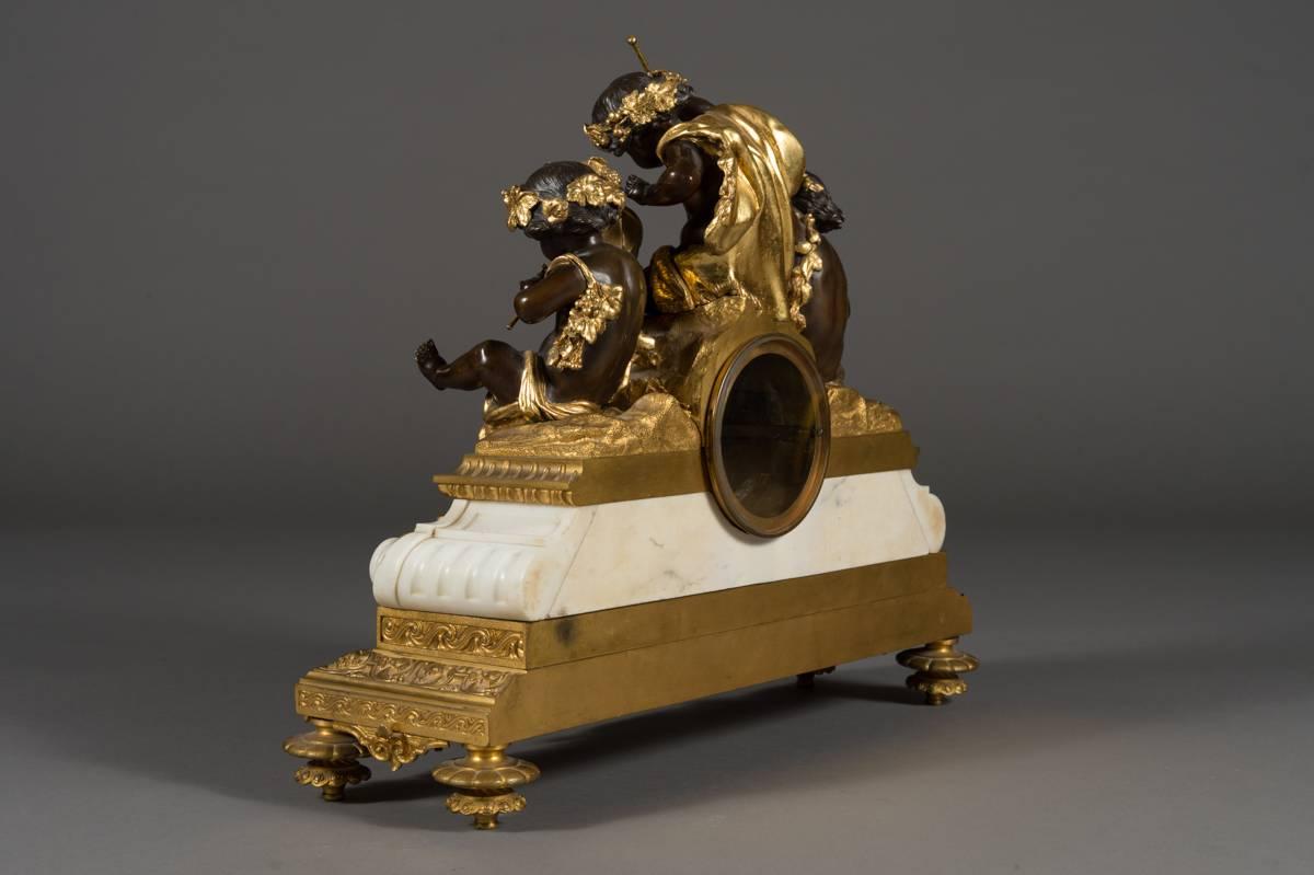 A Very Fine French Antique Ormolu,Patinated Bronze & Marble Mantel Clock

Having three patinated cherubs with gold attributes, each playing an instrument; drums,flute & symbols. The clock dial with Roman & Arabic numerals and gilt bronze hands.