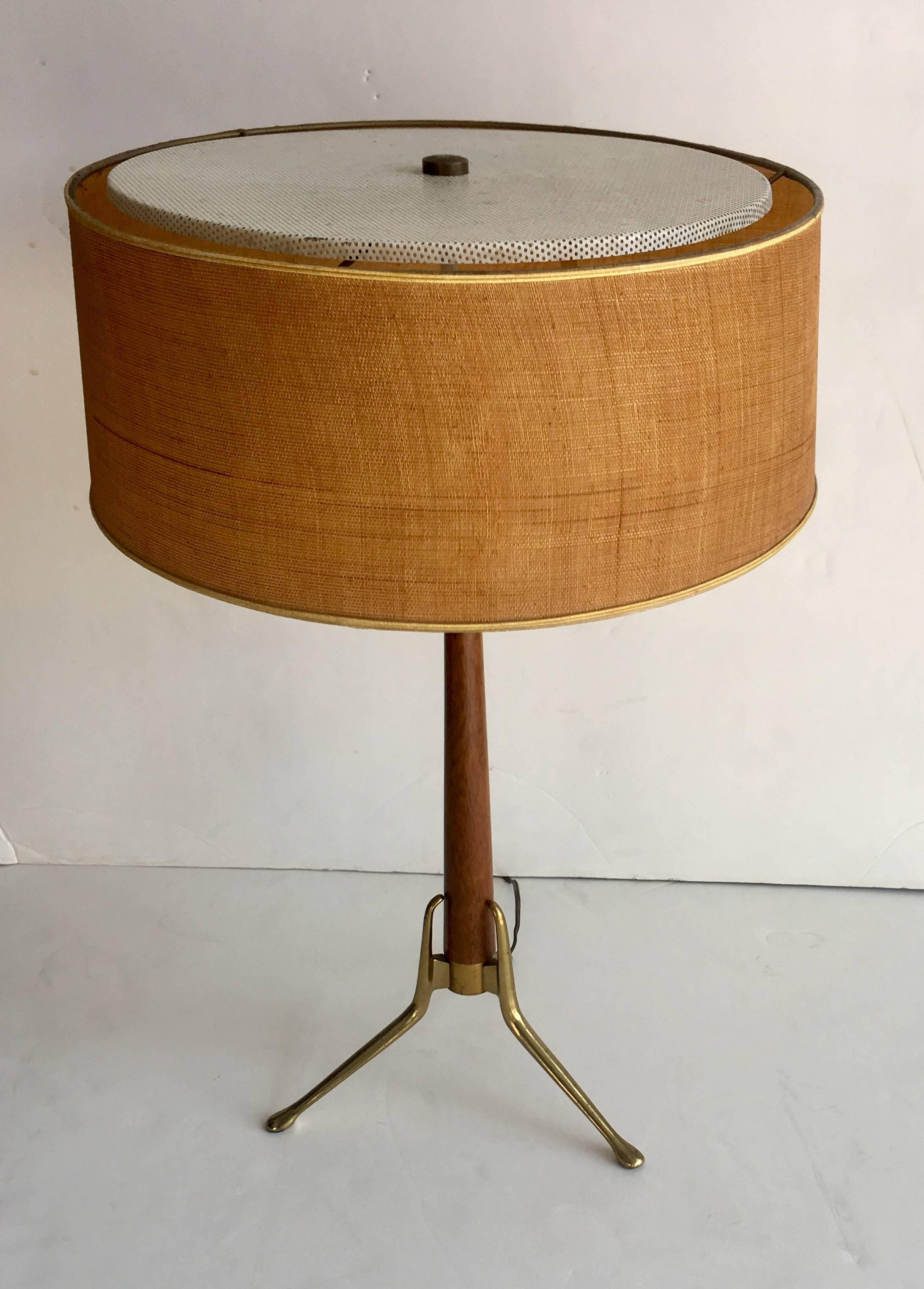 Gorgeous 1950s table lamp by Gerald Thurston. Walnut, brass and linen, with perforated and enameled steel top shade.