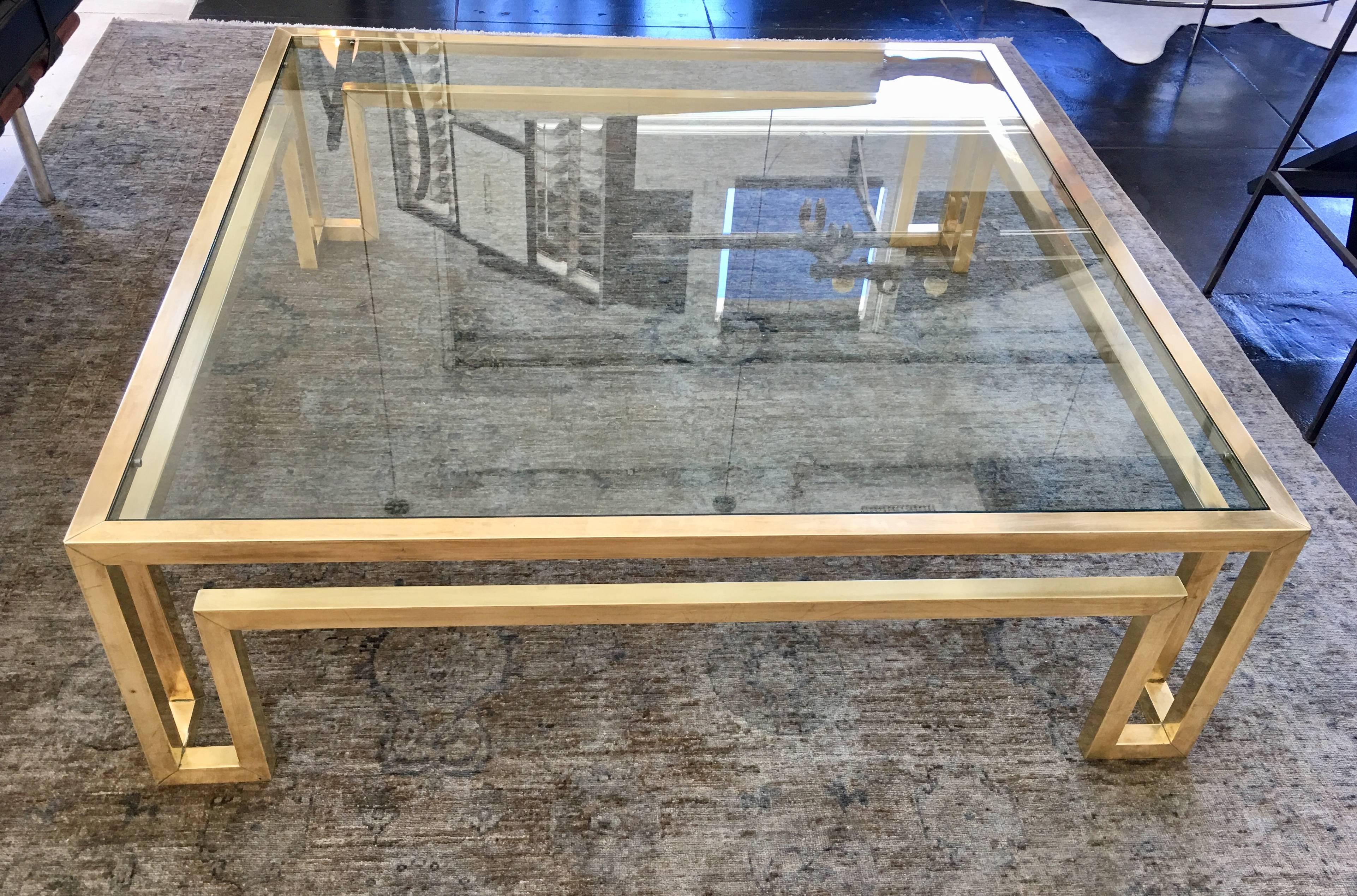 Large and beautiful coffee table by Mastercraft. Solid brass with half inch thick glass.