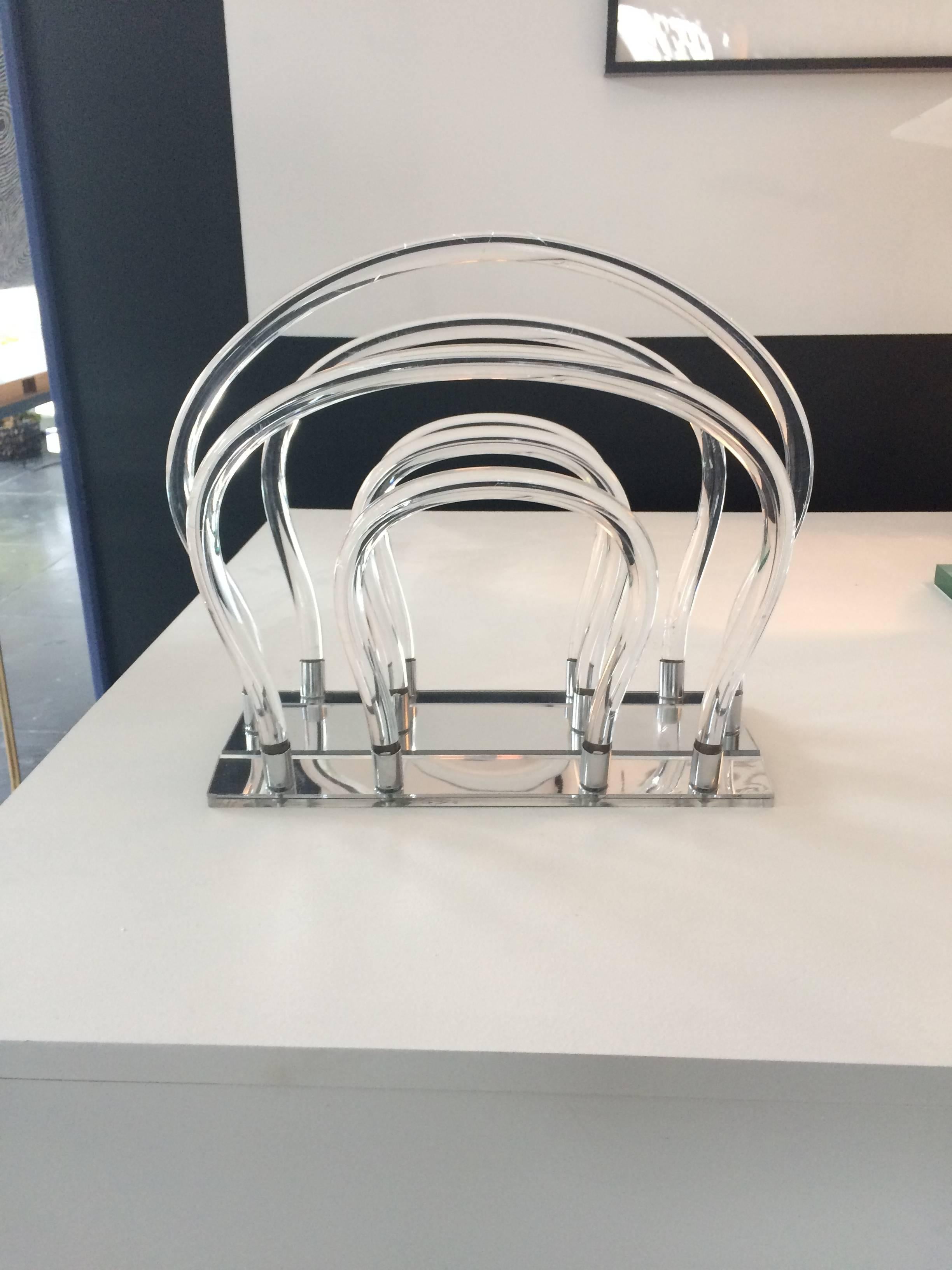 Very unique Lucite magazine holder by Dorothy Thorpe. Six bent Lucite tubes and chrome base.