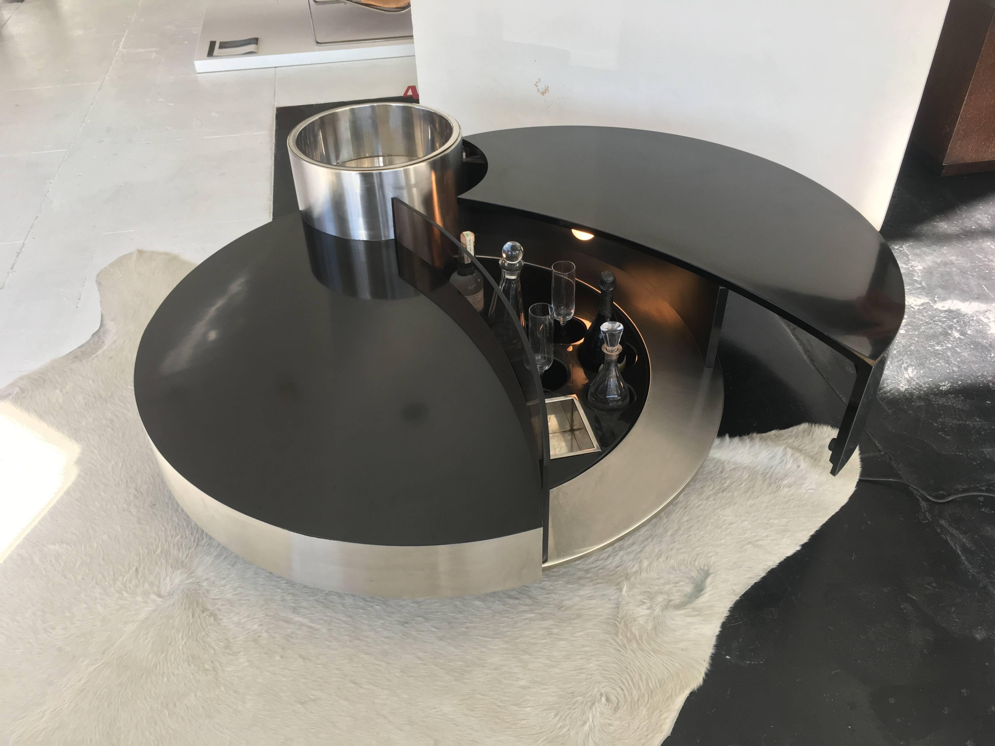 Incredible and unique bar table by Willy Rizzo, 1970s. Illuminated bar table, stainless steel, brushed aluminium, plastic and black laminate, opening to a fitted bar interior. Excellent condition.