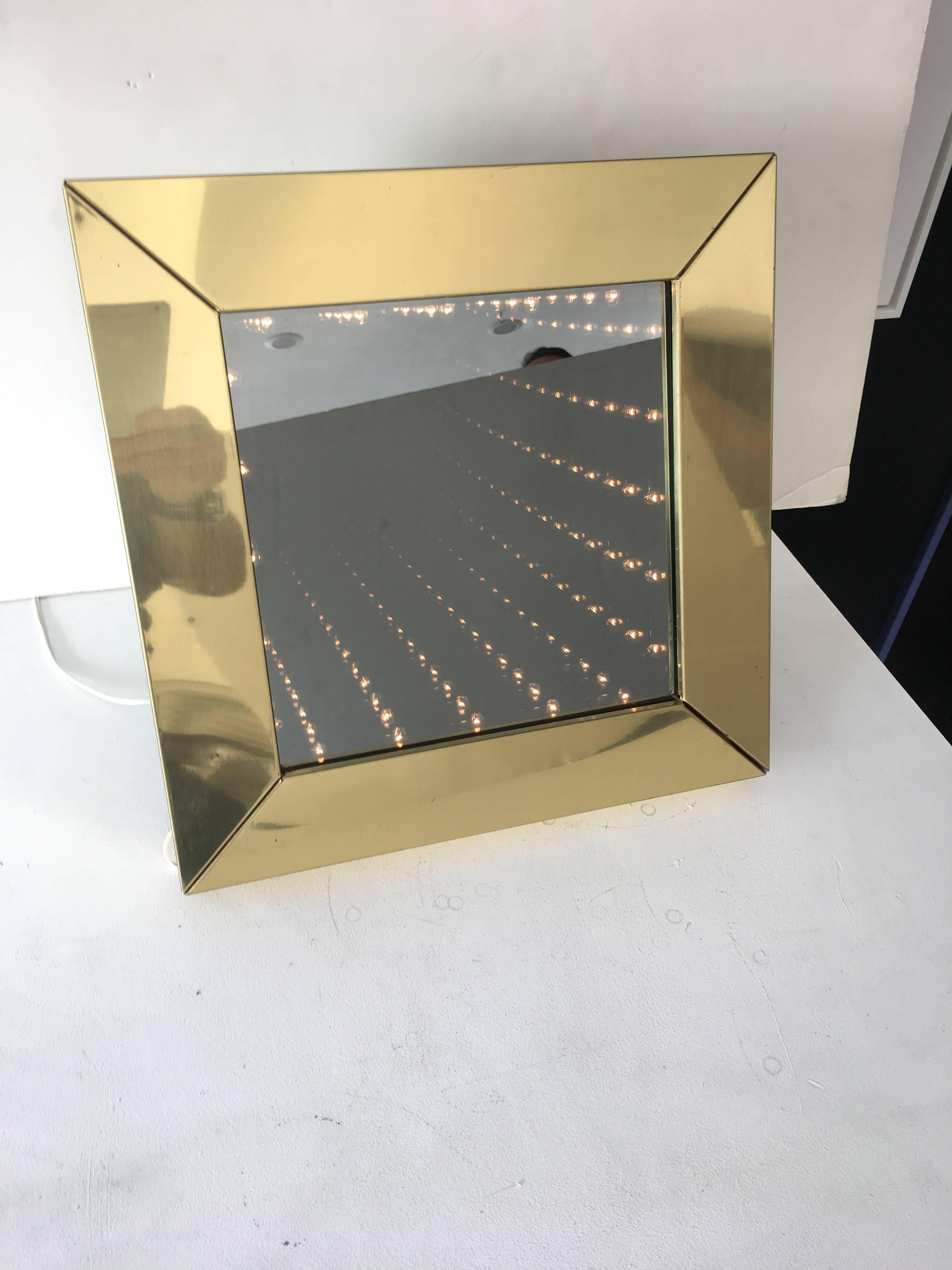 Beautiful infinity mirror with brass frame. Mirror is fully functional with on and off switch. Very good condition.