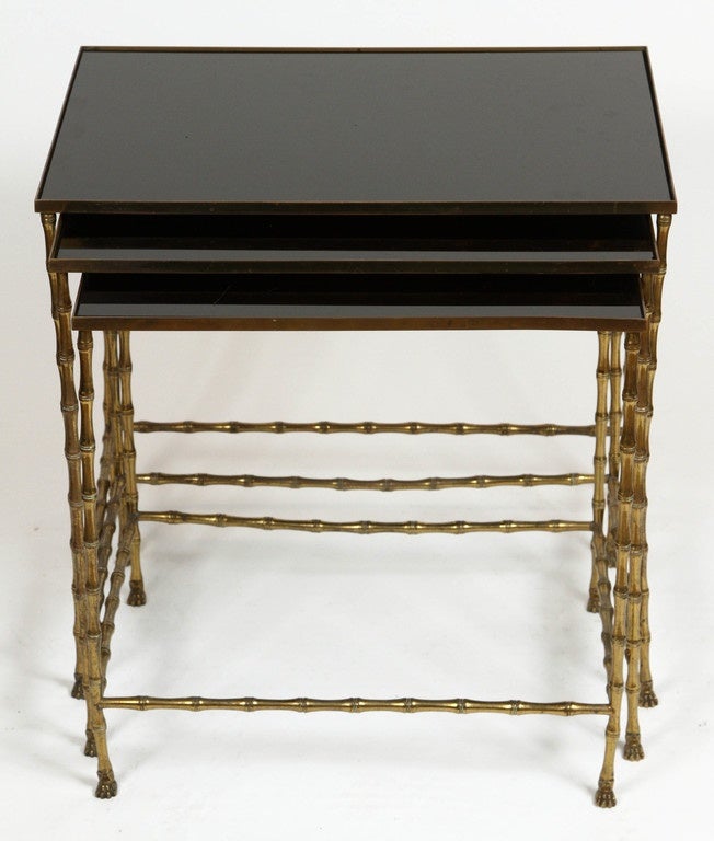 Vintage Maison Baguès bronze nesting tables with black opaline mirror tops. Features legs in a bamboo motif terminating with paws. Set of three tables. Made in France, circa 1950-1970. 

Dimensions:
LG: 19 3/4