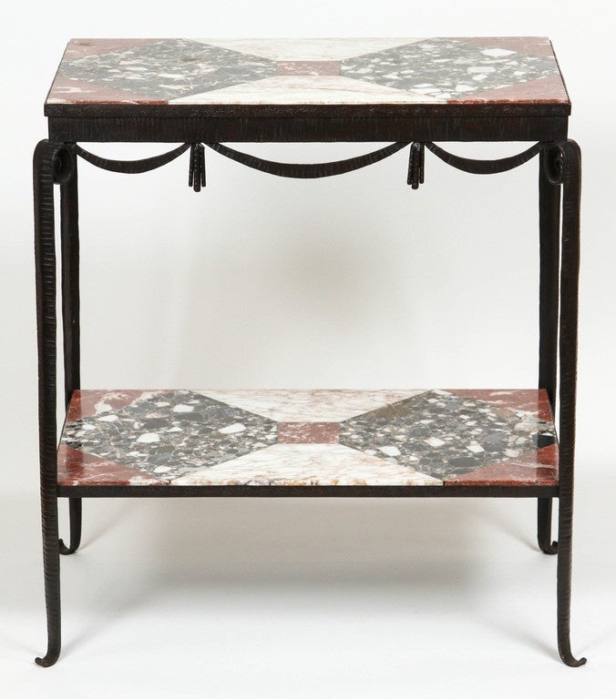 Side table in bronze with swag detail and marble marquetry top.