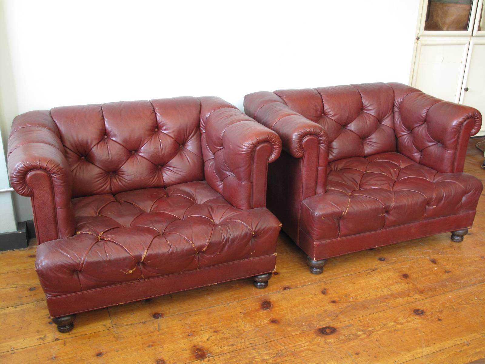 Two 20th century American tufted leather armchairs. Generously wide seat of unusual proportion.