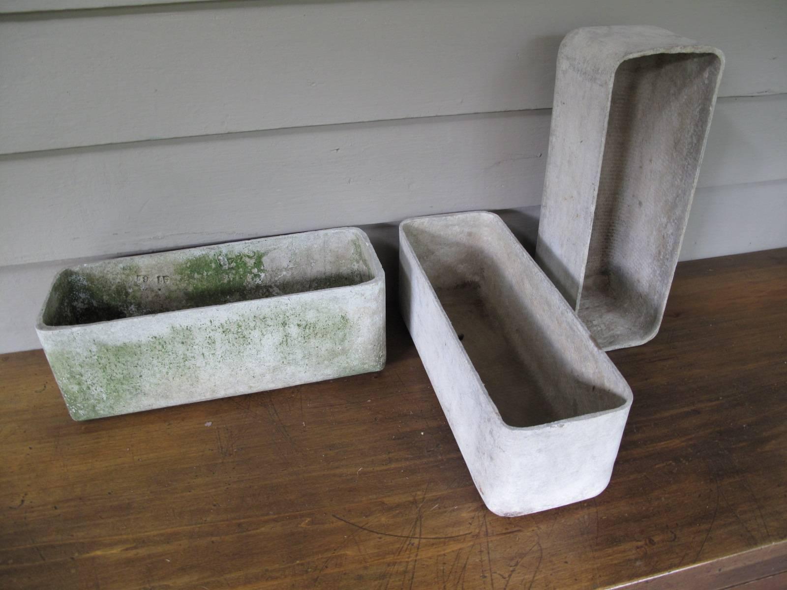Three similar molded fibercrete planters in the manner of Willy Guhl. One planter has numerical markings consistent with original Willy Guhl concrete items while the other two do not and are possibly later production runs from Eternit.