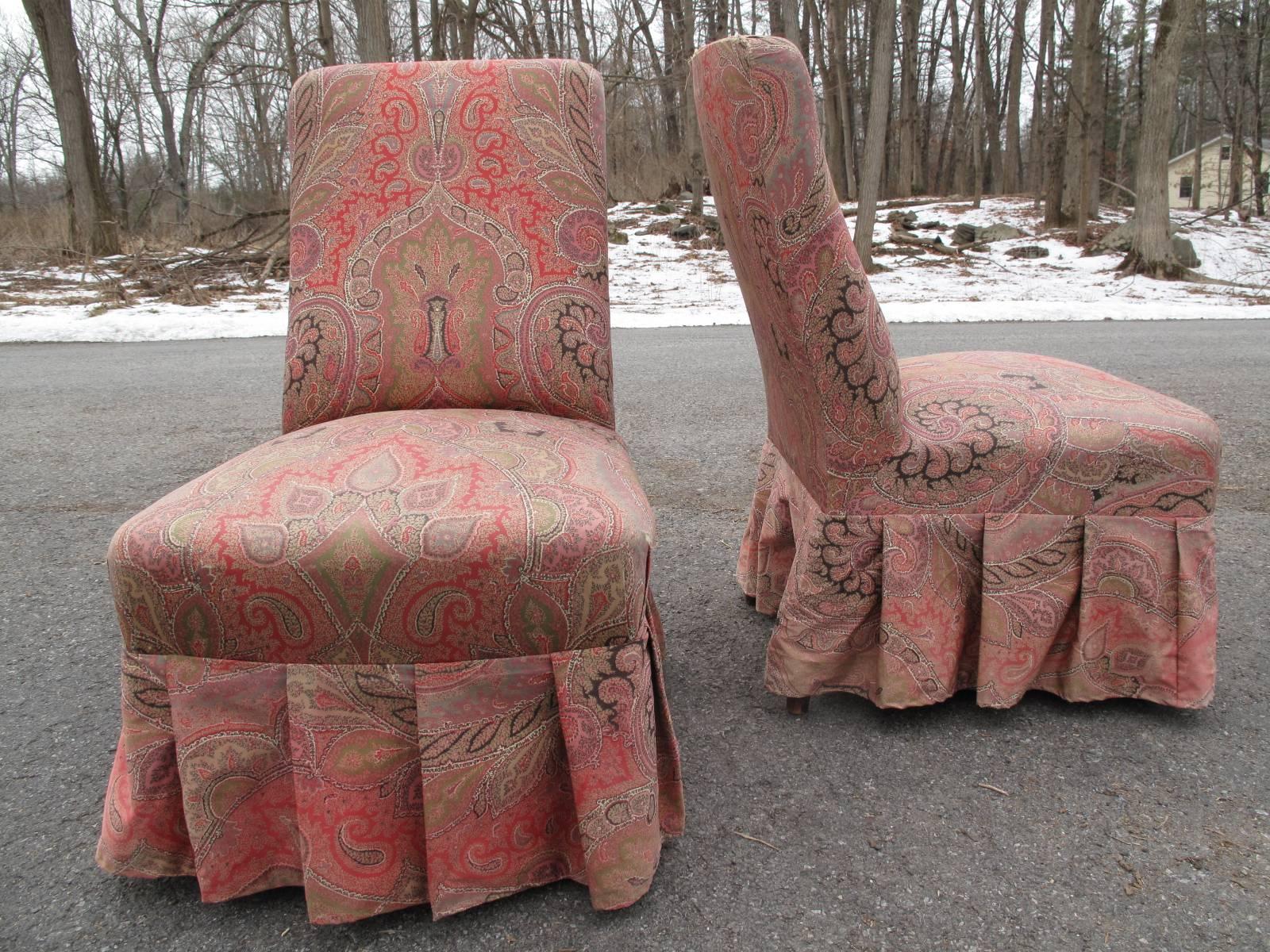 1890s armless high back chairs from France. Upholstered in delicate paisley from Boussac Saint Freres. chairs pre-date the upholstery fabric. Delicate turned legs on brass casters.