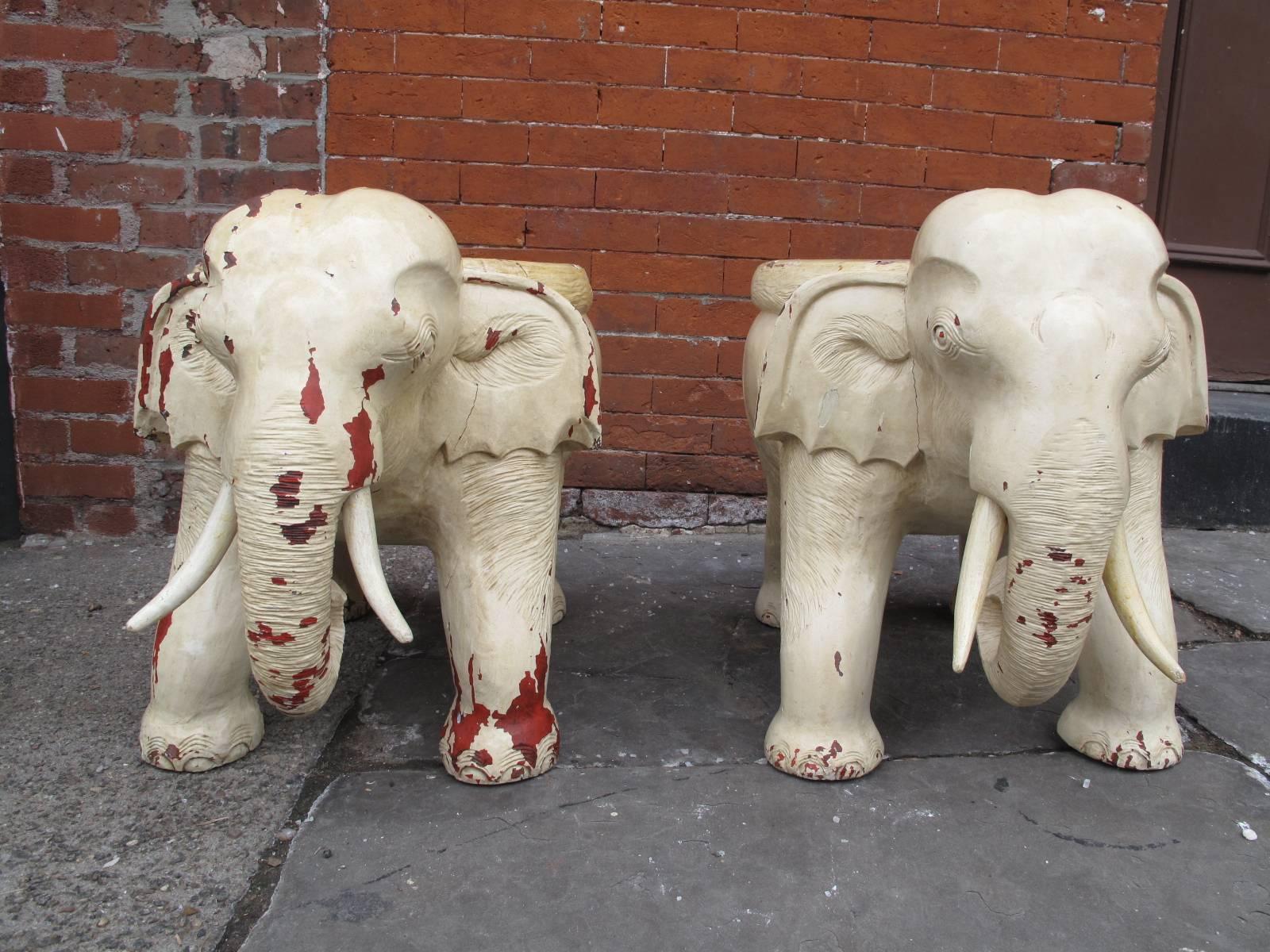 Two garden stools or side tables. Smiling elephants with wood tusks.