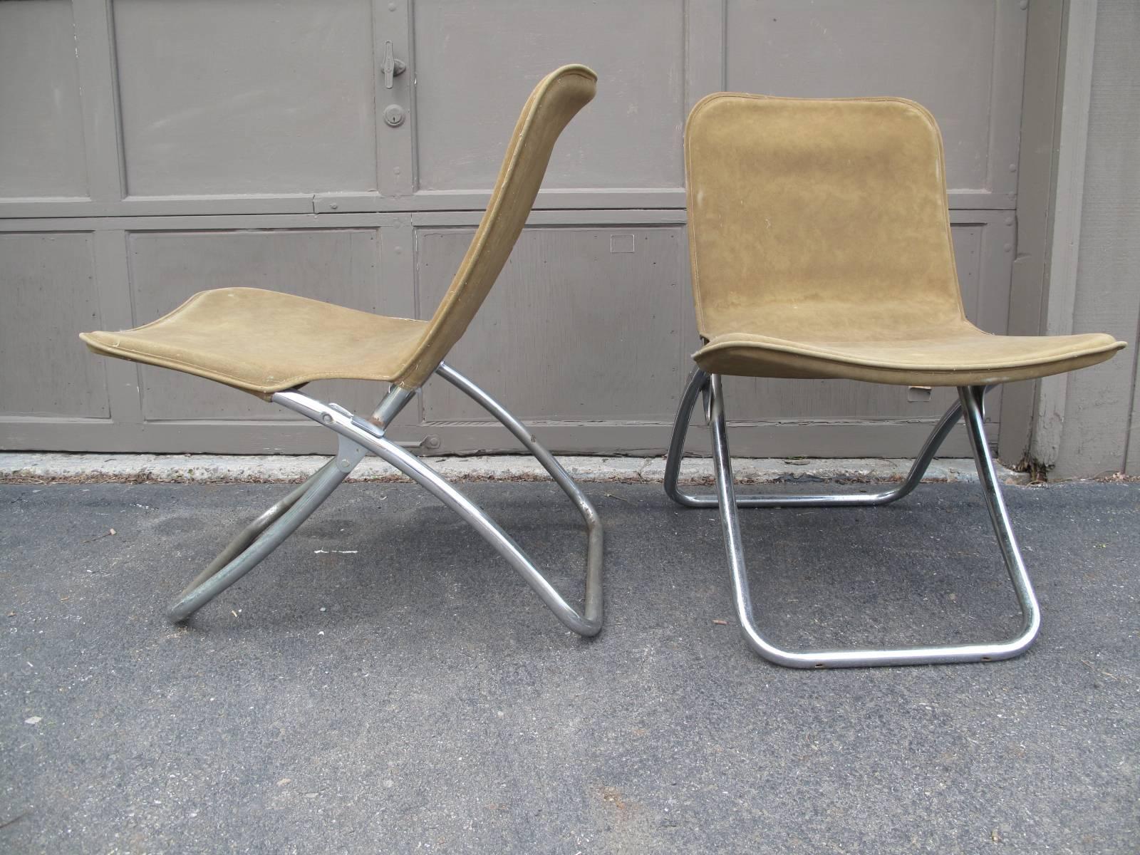 Two 1960s American tubular aluminum folding chairs with original faux suede covers.