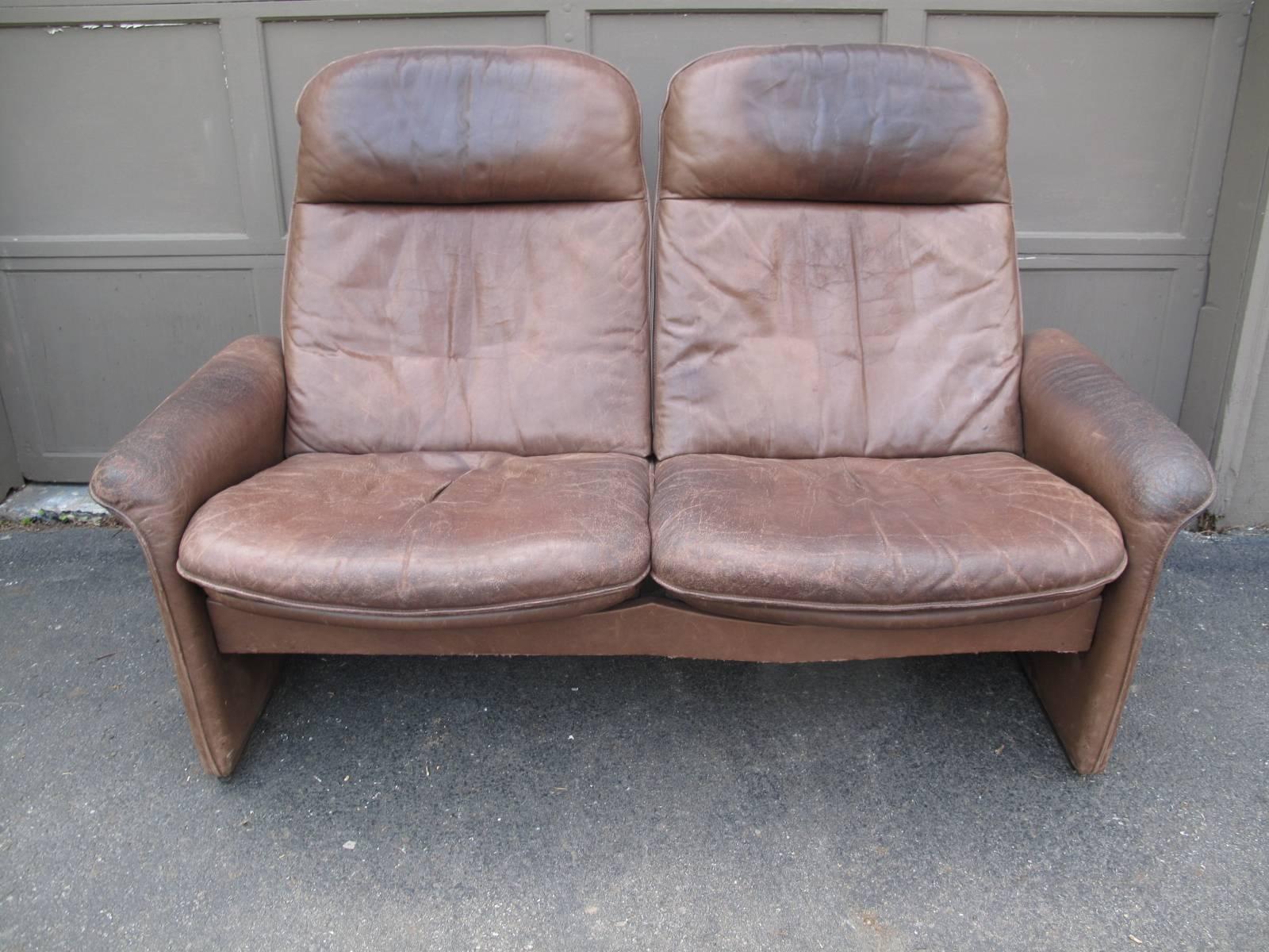 Late 20th century two-person loveseat by Swiss design house De Sede. 

Fabric on underside of the seat is labelled (images available upon request).