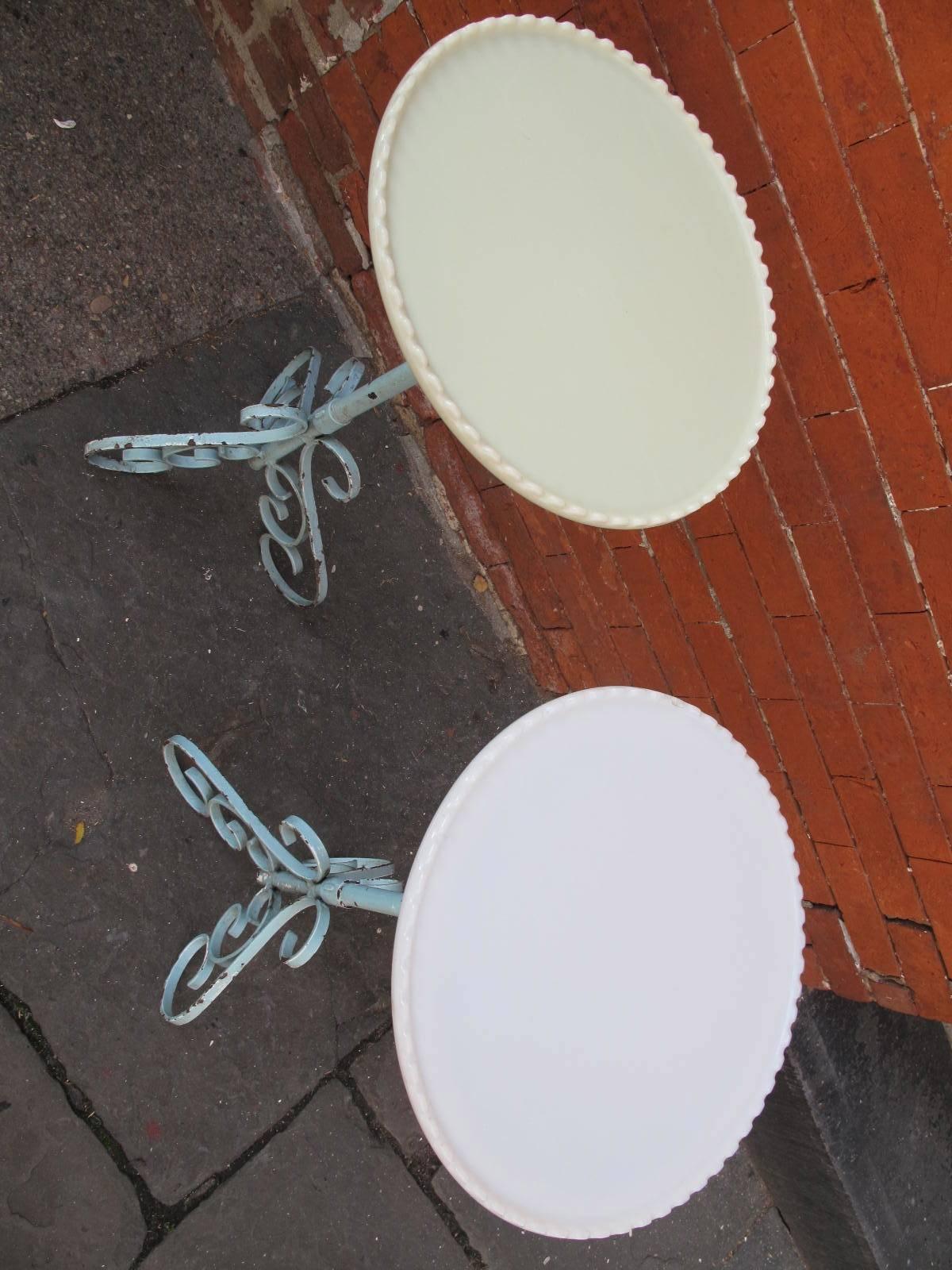Pair of iron stands in robin's egg blue paint. Each having scalloped milk glass plates resting atop the frame. Please note: milk glass is slightly different shades of ivory as shown. Plates are not permanently adhered to bases. Available as a pair.