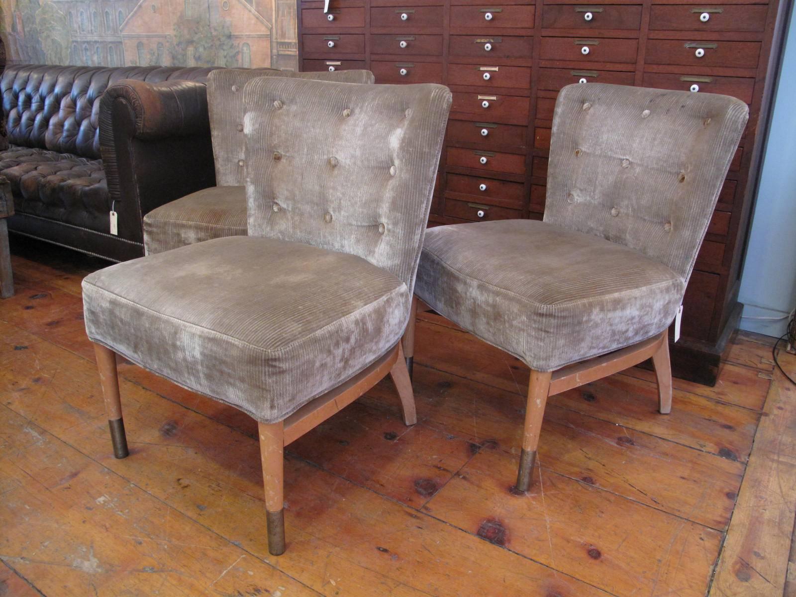 Three midcentury upholstered side chairs in original cotton silk velvet. Button tufted backs. Oversized brass sheaths overtop front legs. Available individually.