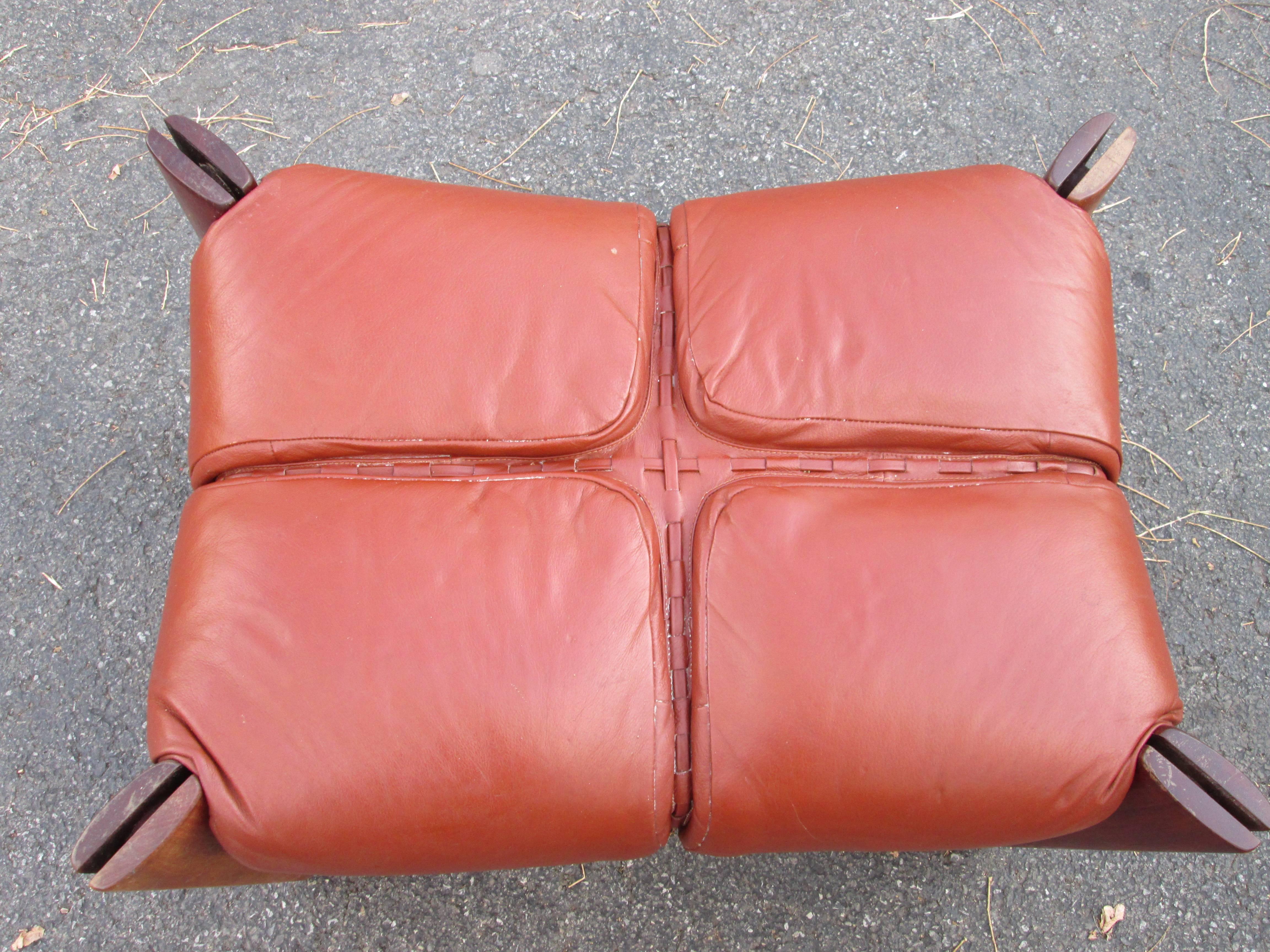 Original midcentury leather ottoman by Percival Lafer. 