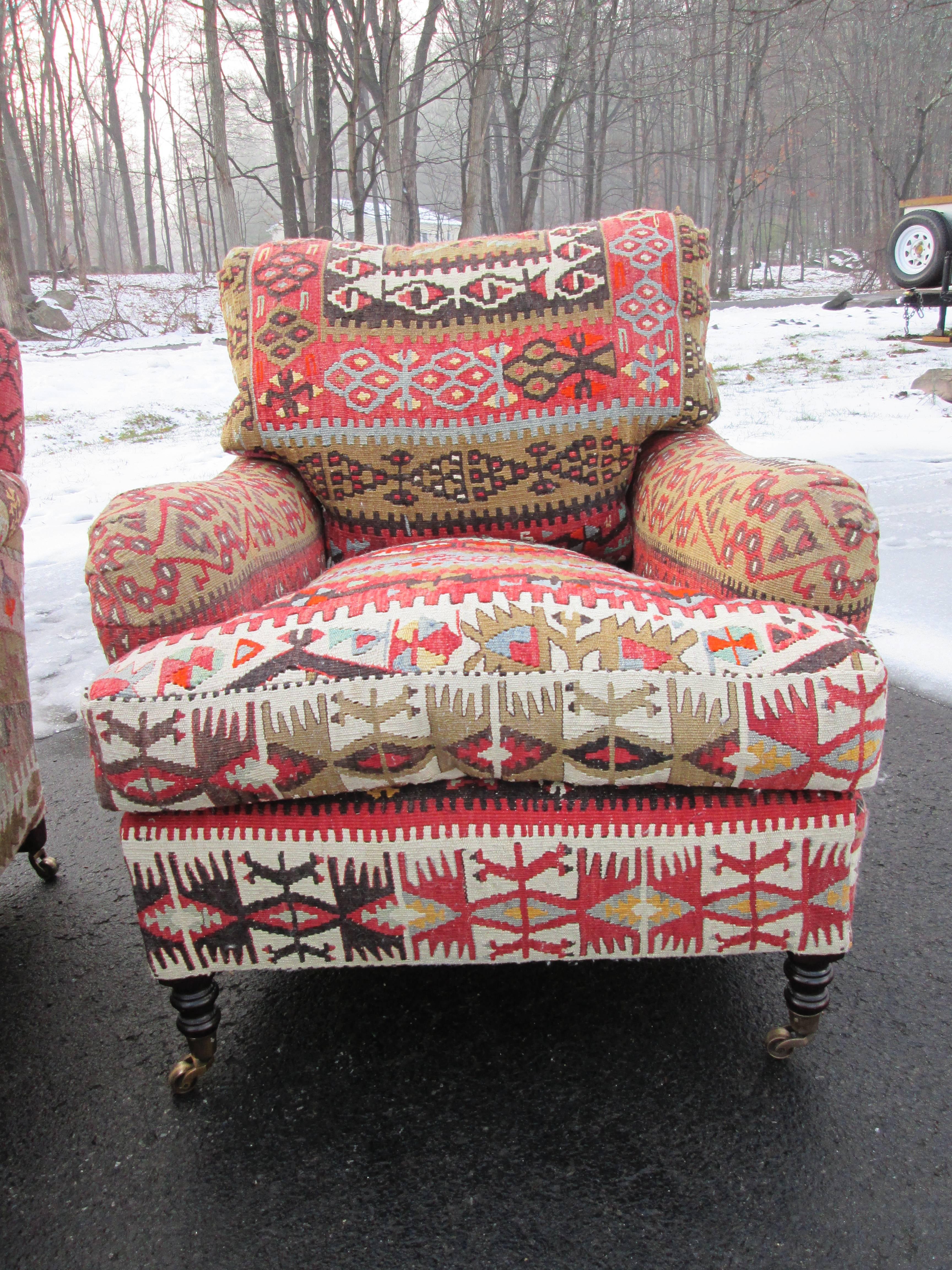 Similar pair of George Smith chairs, upholstered in wool Kilim. Medium standard armchair. Casters on all four legs. Loose cushion back and seat. Made in England. Sold individually.