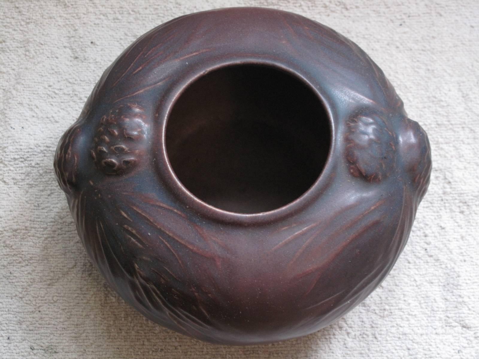 Pinecone pot in plum glaze by American Arts & Crafts potter Artus Van Briggle. No apparent date, however four distinct hash marks appear below the Van Briggle mark on the base of the vase.
