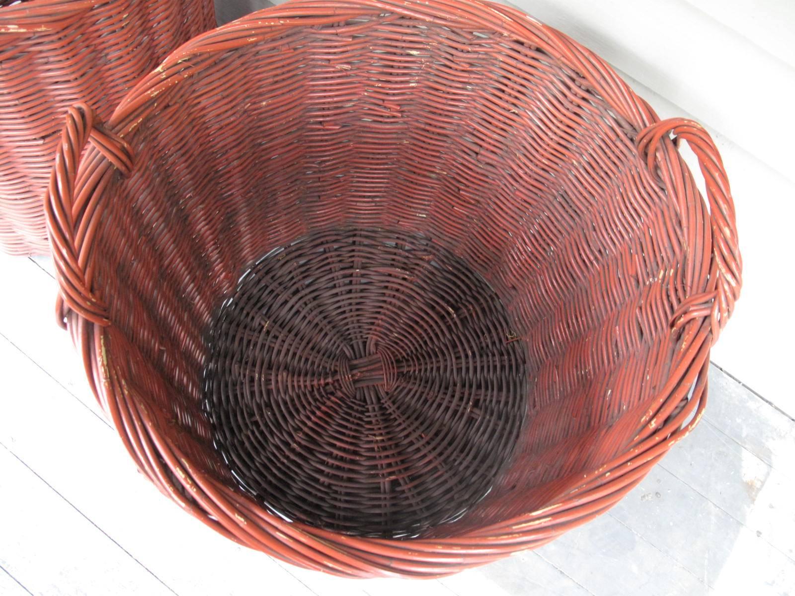 Mid-20th Century Pair of Large Woven Baskets in Red Paint