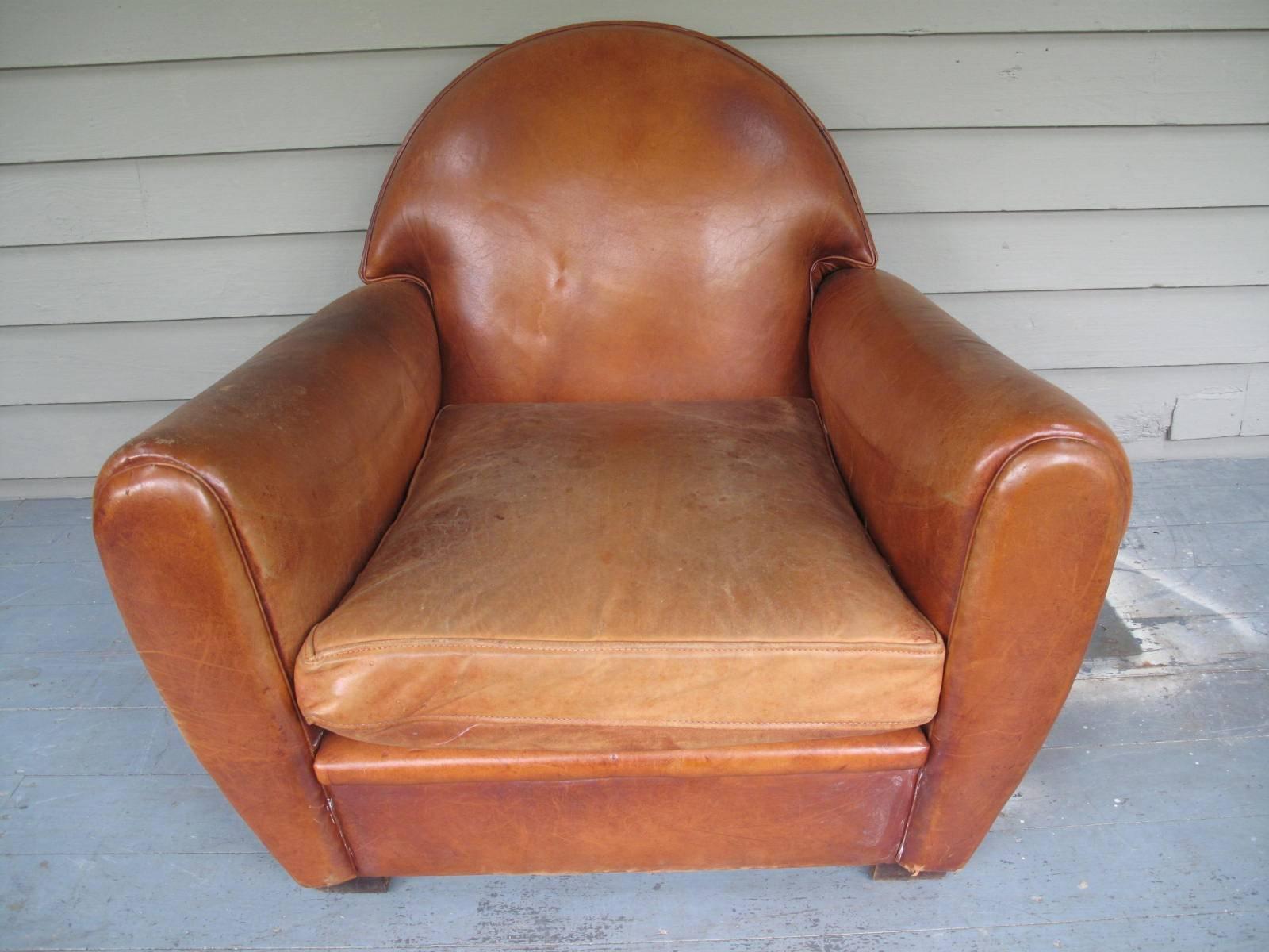 French 1940s armchair in original leather. Single loose cushion. Large footprint.