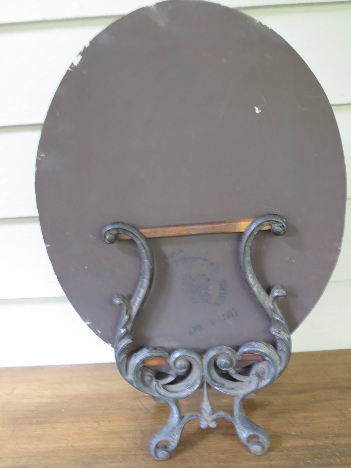 19th Century Oval Mirror in Ornate Cast Iron Base