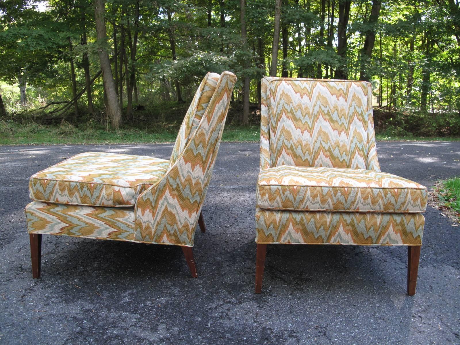 Pair of armless chairs in original multicolor upholstery.
