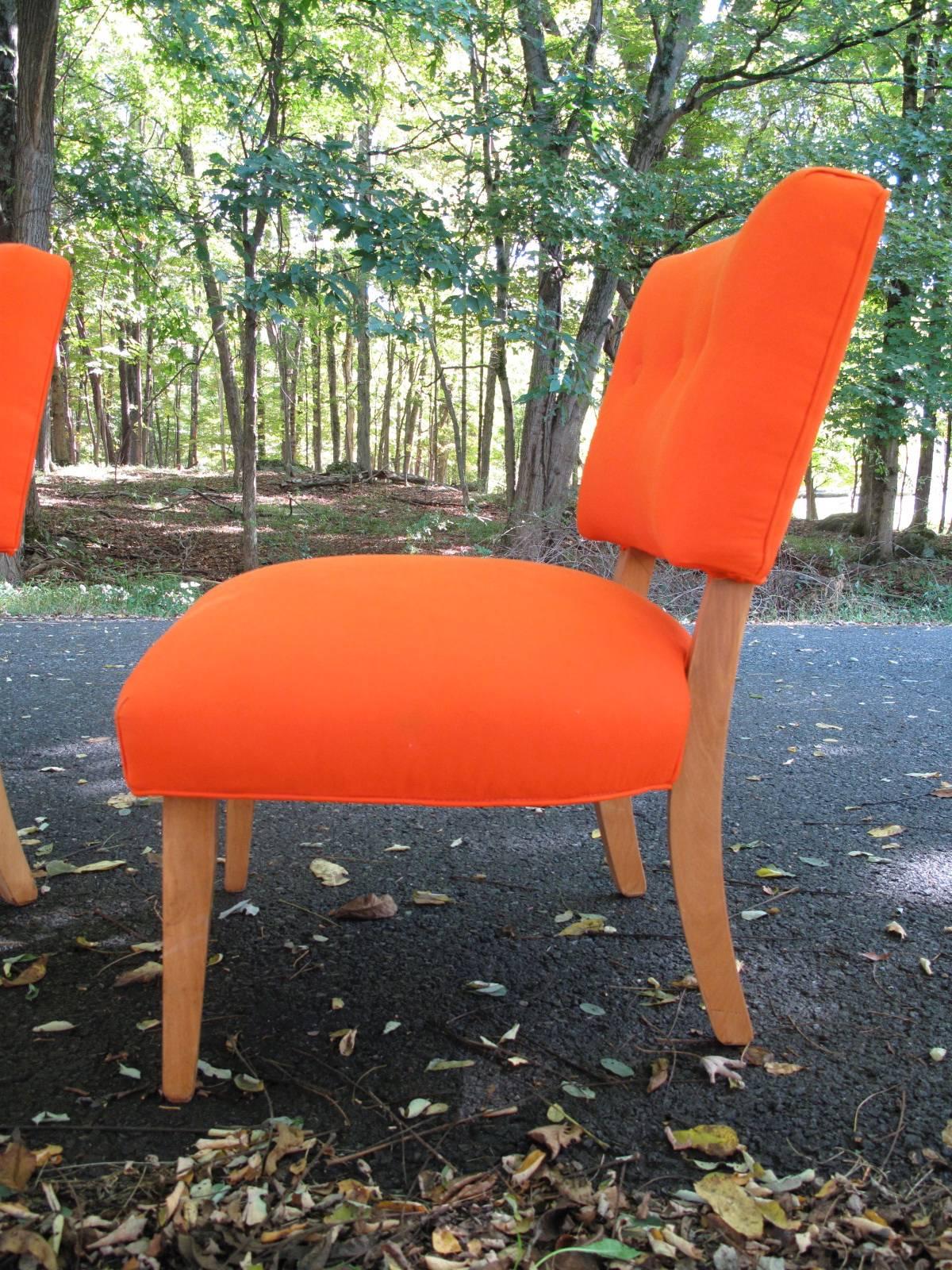 Two button-tufted Mid-Century Modern armless chairs. Recently upholstered in electric orange cotton.