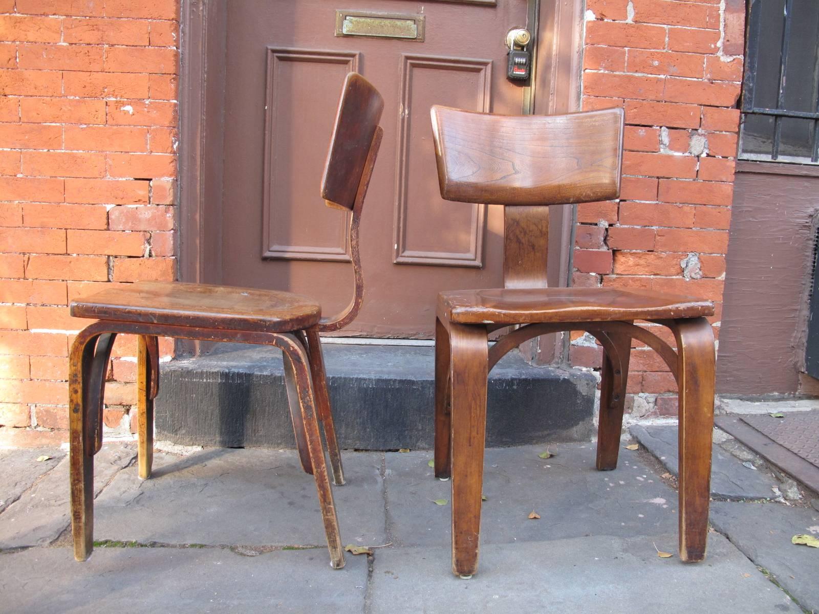 Four Mid-Century Modern thonet chairs with wide seats.