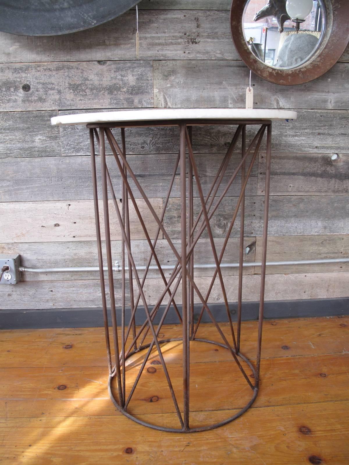 Sculptural pedestal table. Multiple wrought iron intersecting struts. Measure 30
