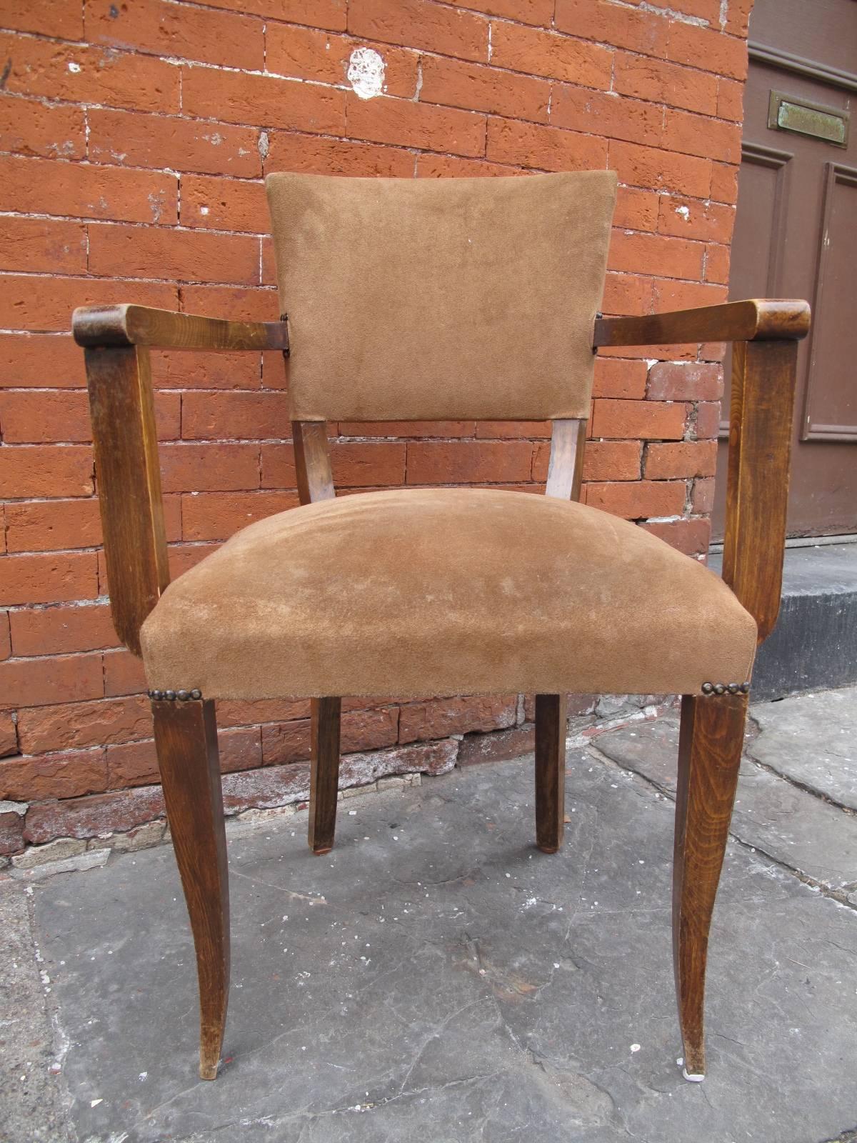 Elegant 1940s American armchair in suede upholstery. Tapered legs. Nailhead details.
