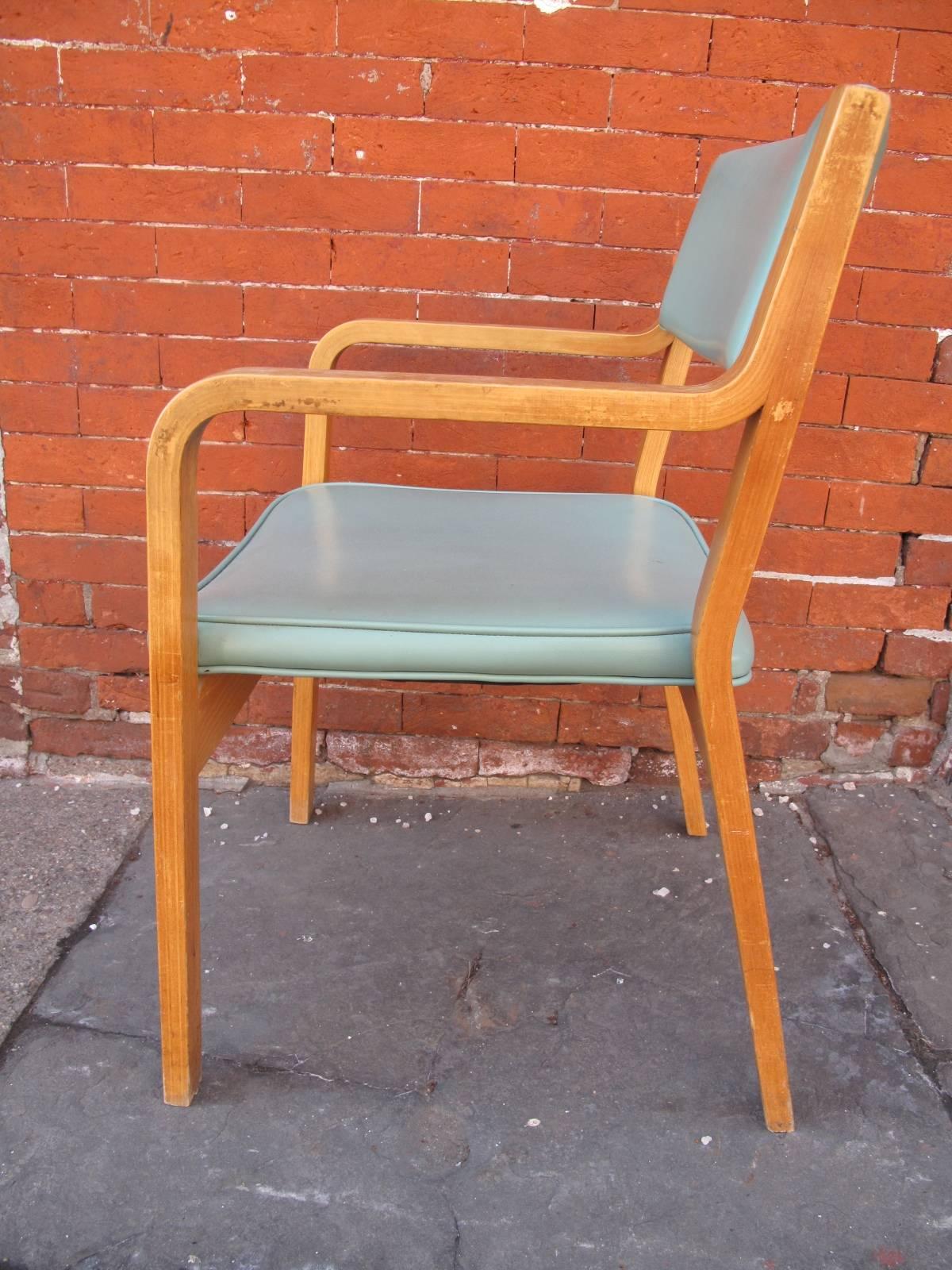 Mid-Century Modern oak and turquoise vinyl armchairs. Manufactured by Thonet in the mid-20th century. Available individually. Total of 11 chairs.
