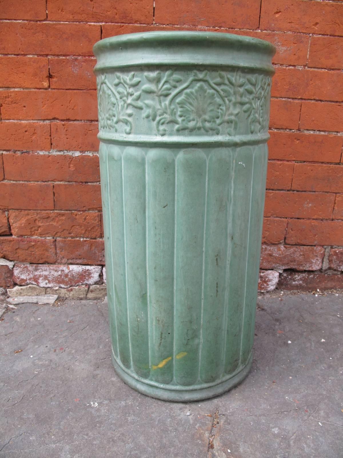 Cylindrical pottery umbrella stand in the manner of Roseville or Weller. In matte green glaze.