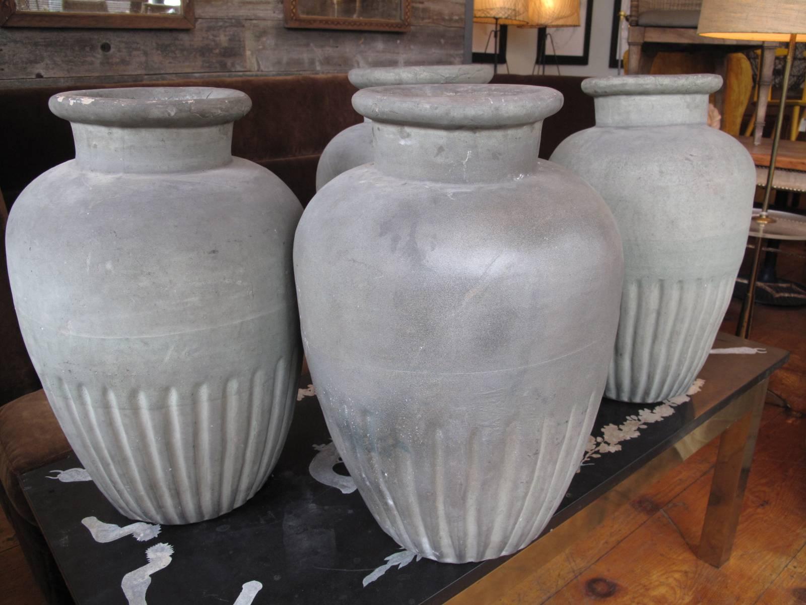 Four similar handmade urns with original zinc inserts. Subtle color shift in glaze on lower portion. Likely late 19th century, though undated. Listed as a set of four but we may consider offers on pairs only. 

Measurements of each vase vary
