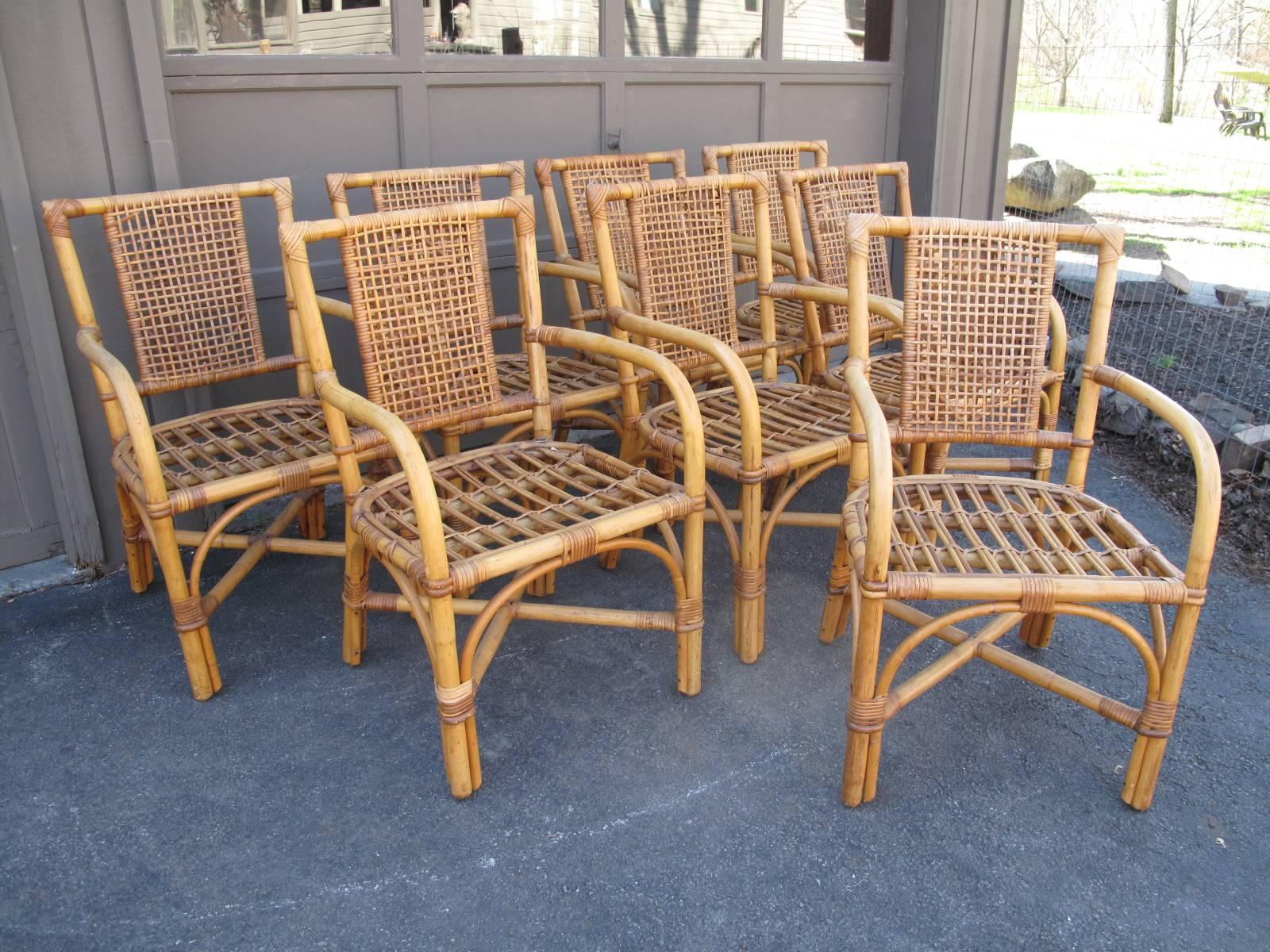 Four (remaining of original eight pictured) wrapped bamboo garden chairs. Striped blue and white foam cushions. Sold individually. Please contact us for group pricing.

Seat height without cushions: 16.5".