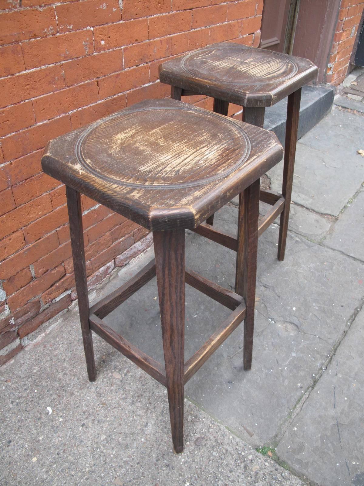 Oak tall stools with octagonal tops. Remnants of the label underneath as shown, illegible. Likely of American design and manufacture. Available as a pair.