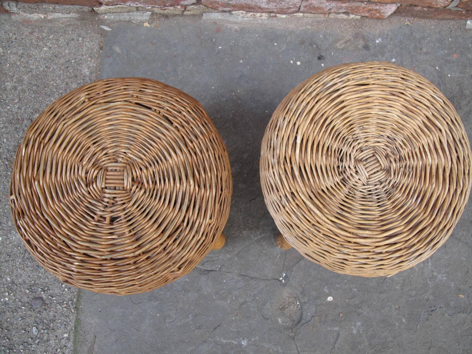 Two petite Mid-Century rattan foot stools, likely by American designer Tony Paul. Available as a pair.