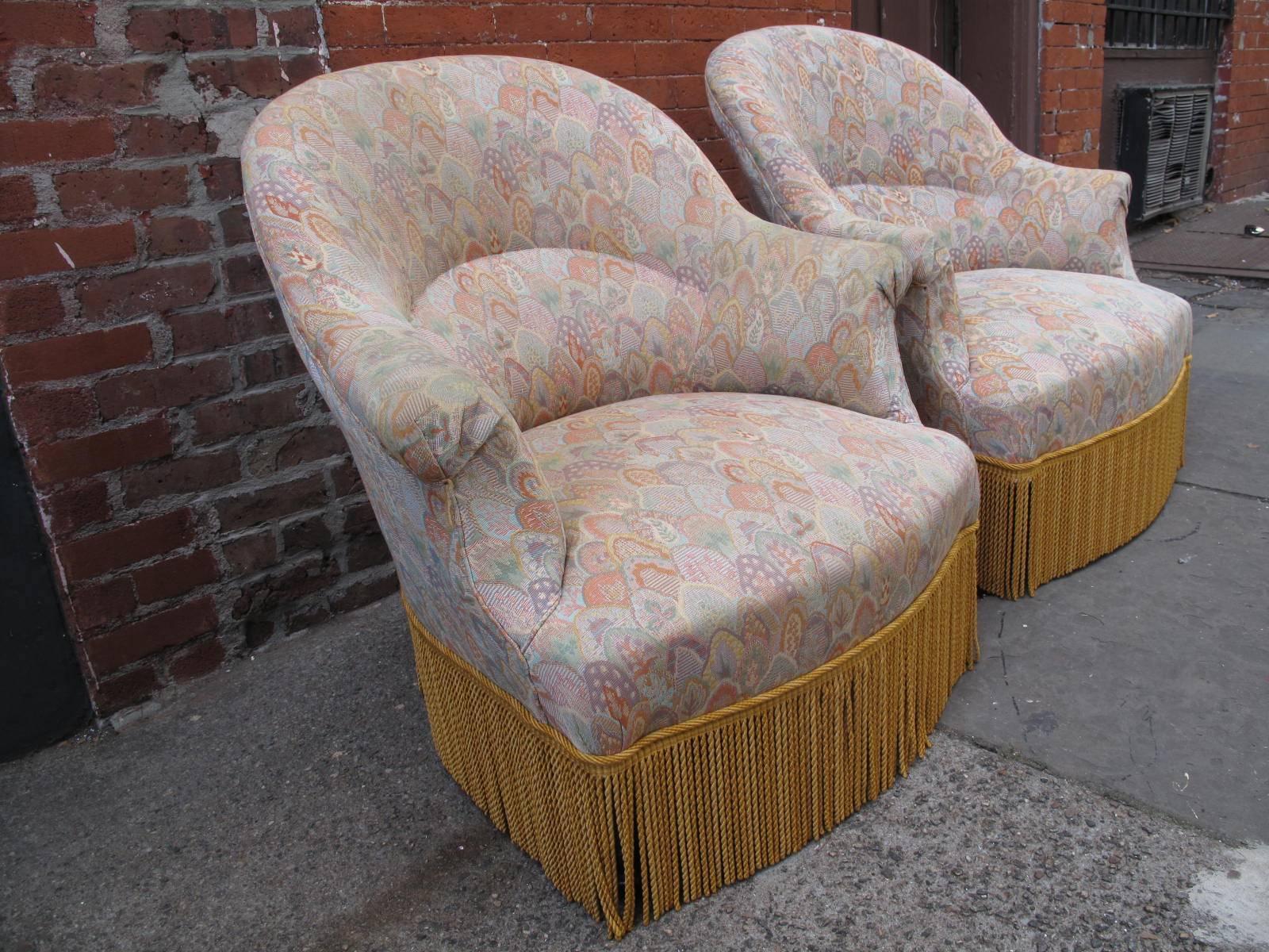 Two late 19th century French chairs. Ebonized legs under gold fringe. Pastel scallop upholstery, likely not original to chair frames. Available as a pair.